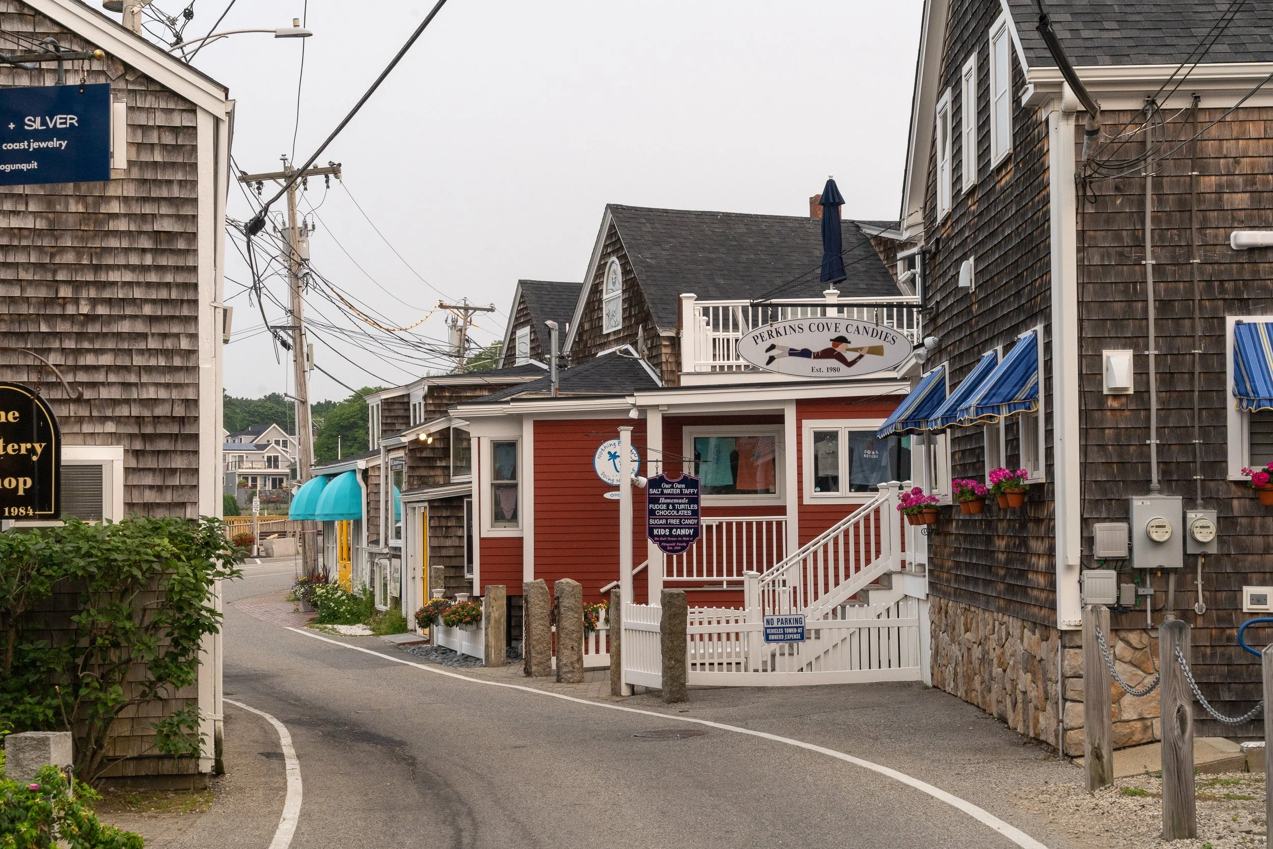 Narrow village street lined with shops in Perkins Cove