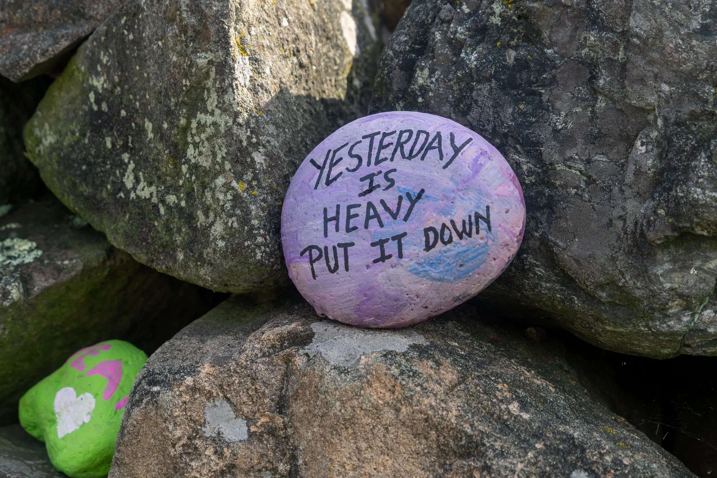 Painted stone reading, "Yesterday was heavy. Put it down."