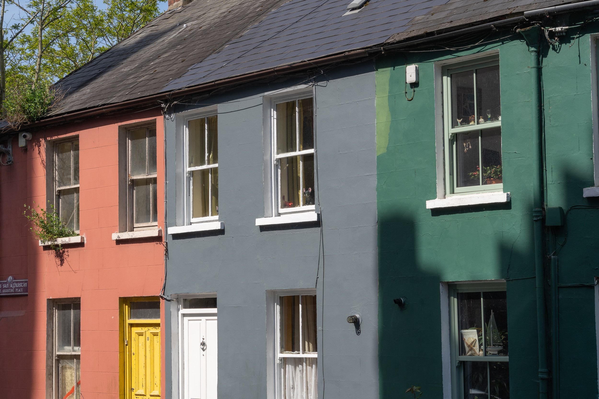 A row of colorful Irish townhouses reflects the warmth and character found in everyday streets, where vibrant facades brighten even the simplest moments.