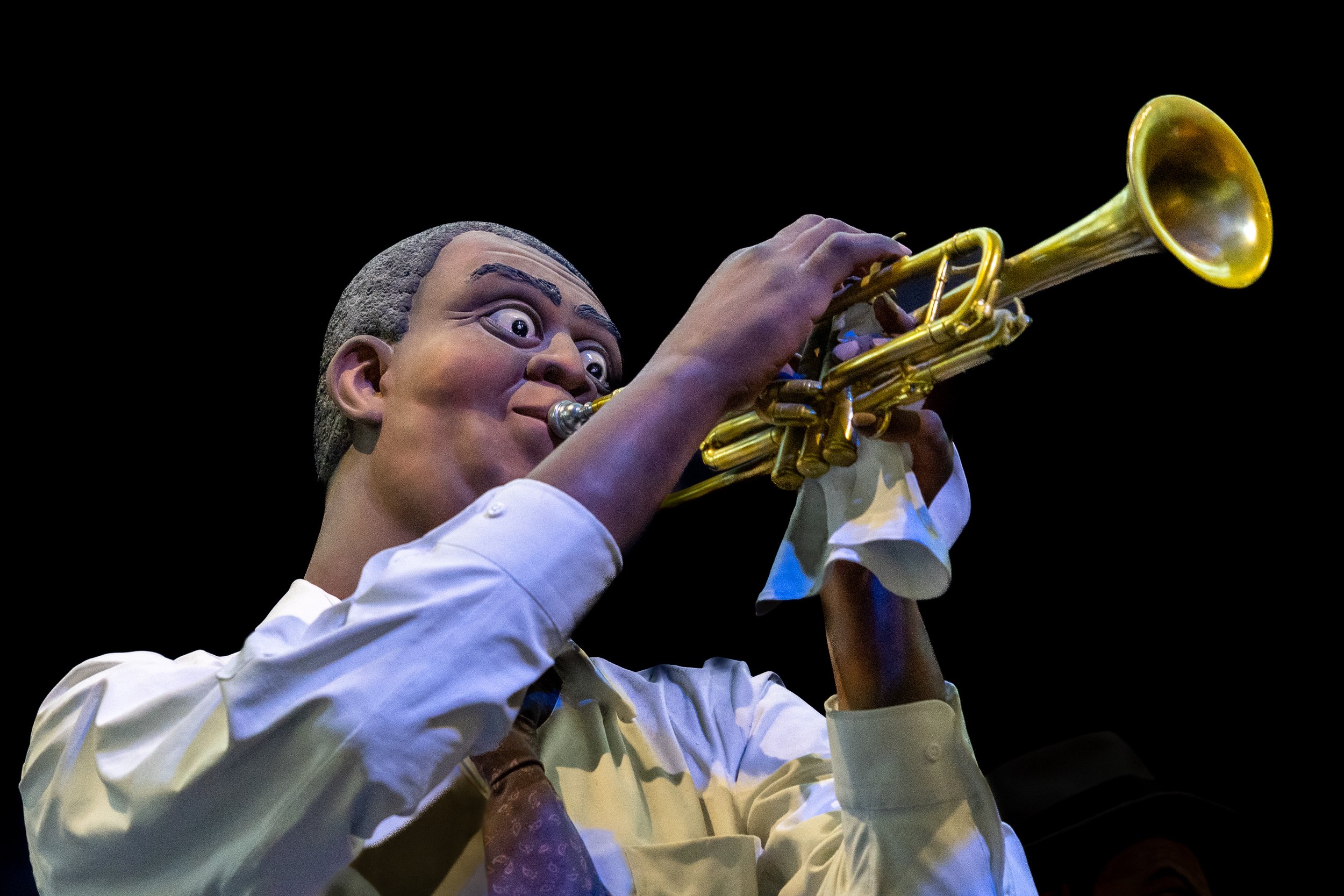 Close-up of a jazz trumpeter sculpture performing against a black background at Grounds For Sculpture in Hamilton, New Jersey.