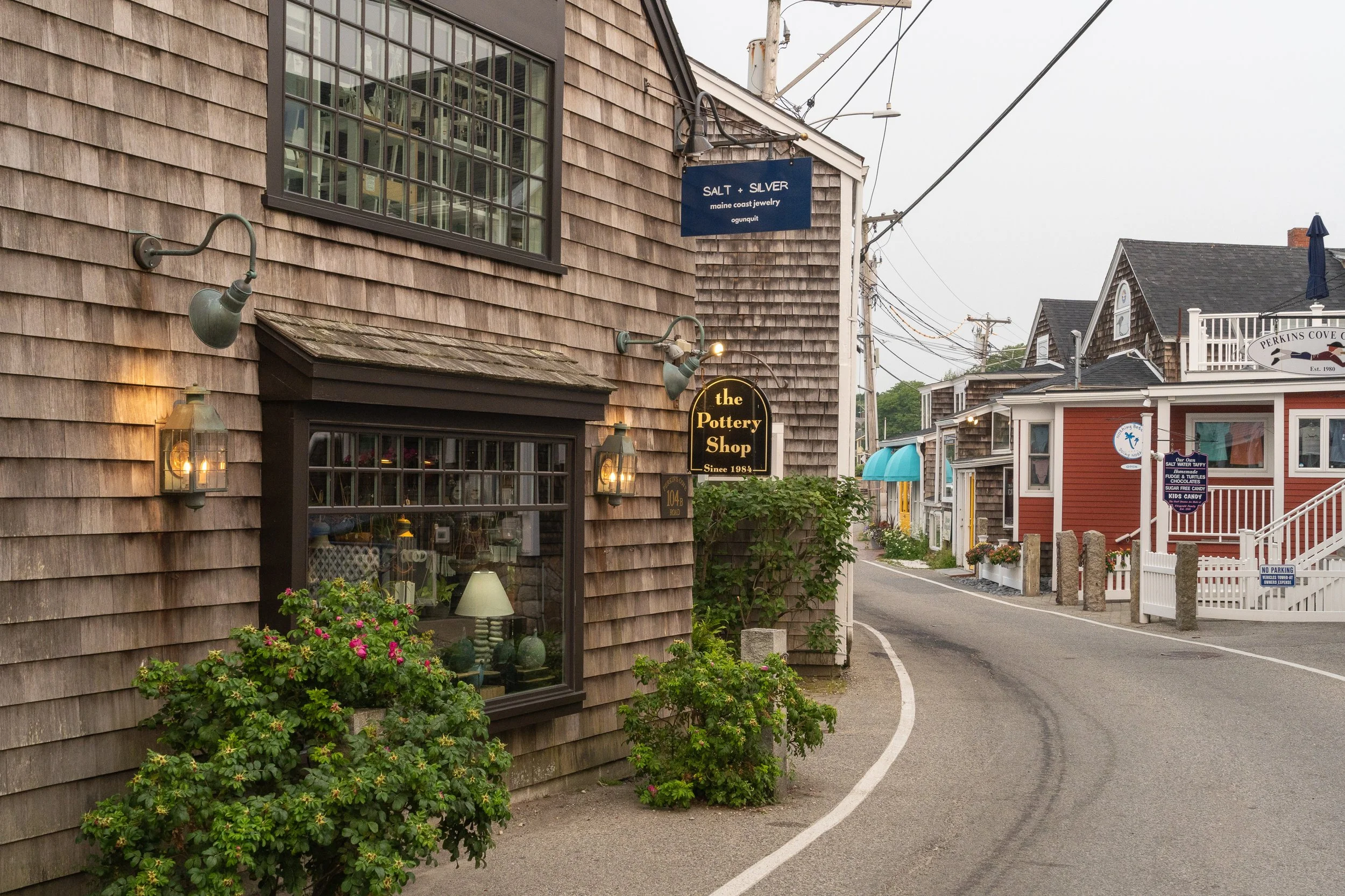 Shops and cottages lining a street in Perkins Cove