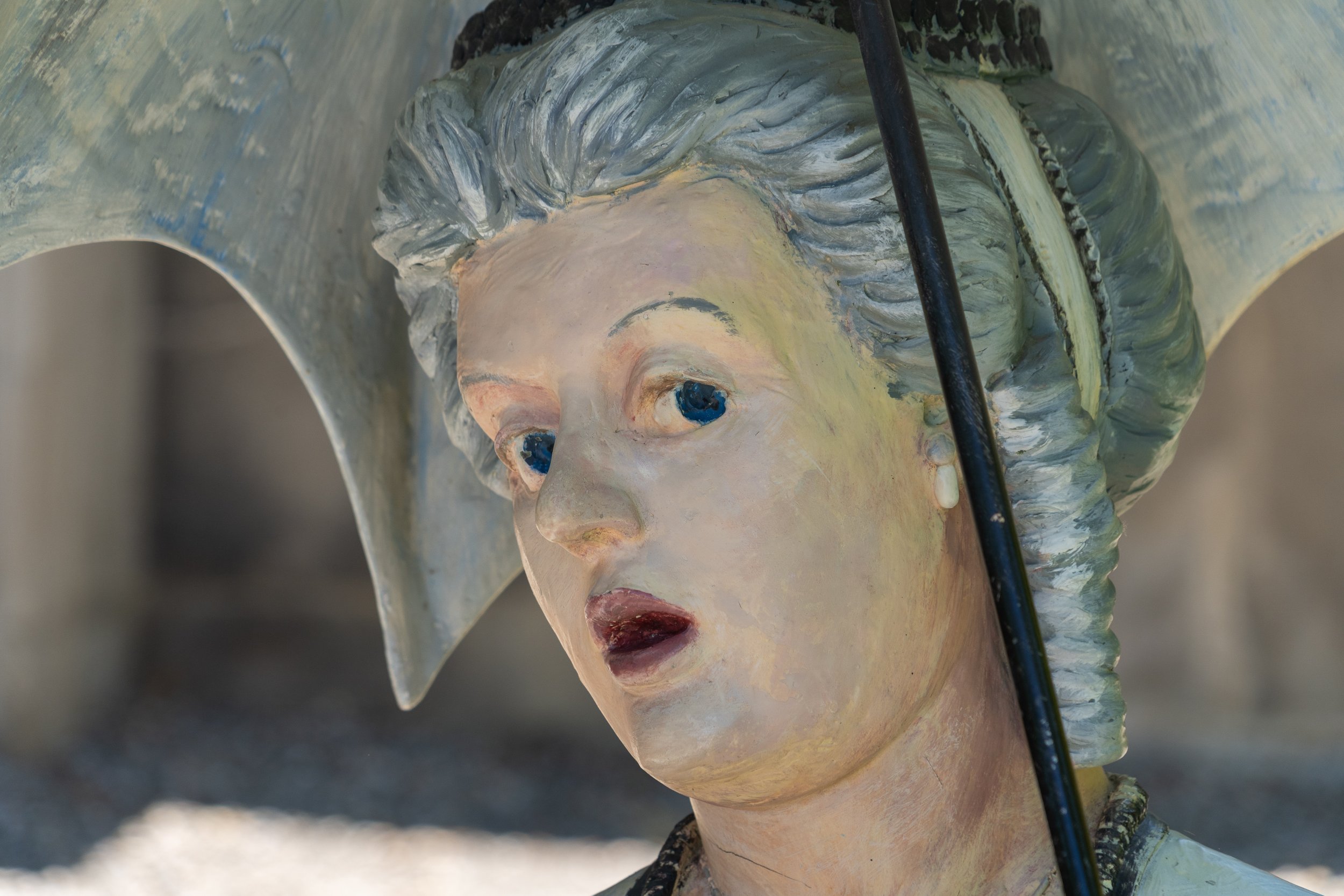 Close-up of a woman sculpture beneath a parasol at Grounds For Sculpture in Hamilton, New Jersey.