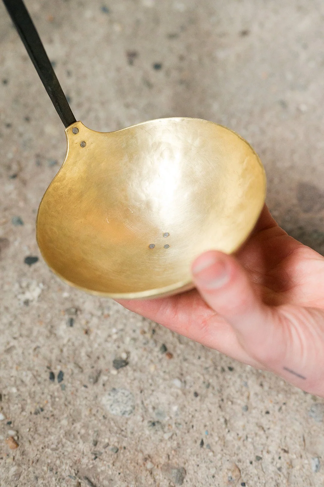 Formed brass ladle with rivet detail