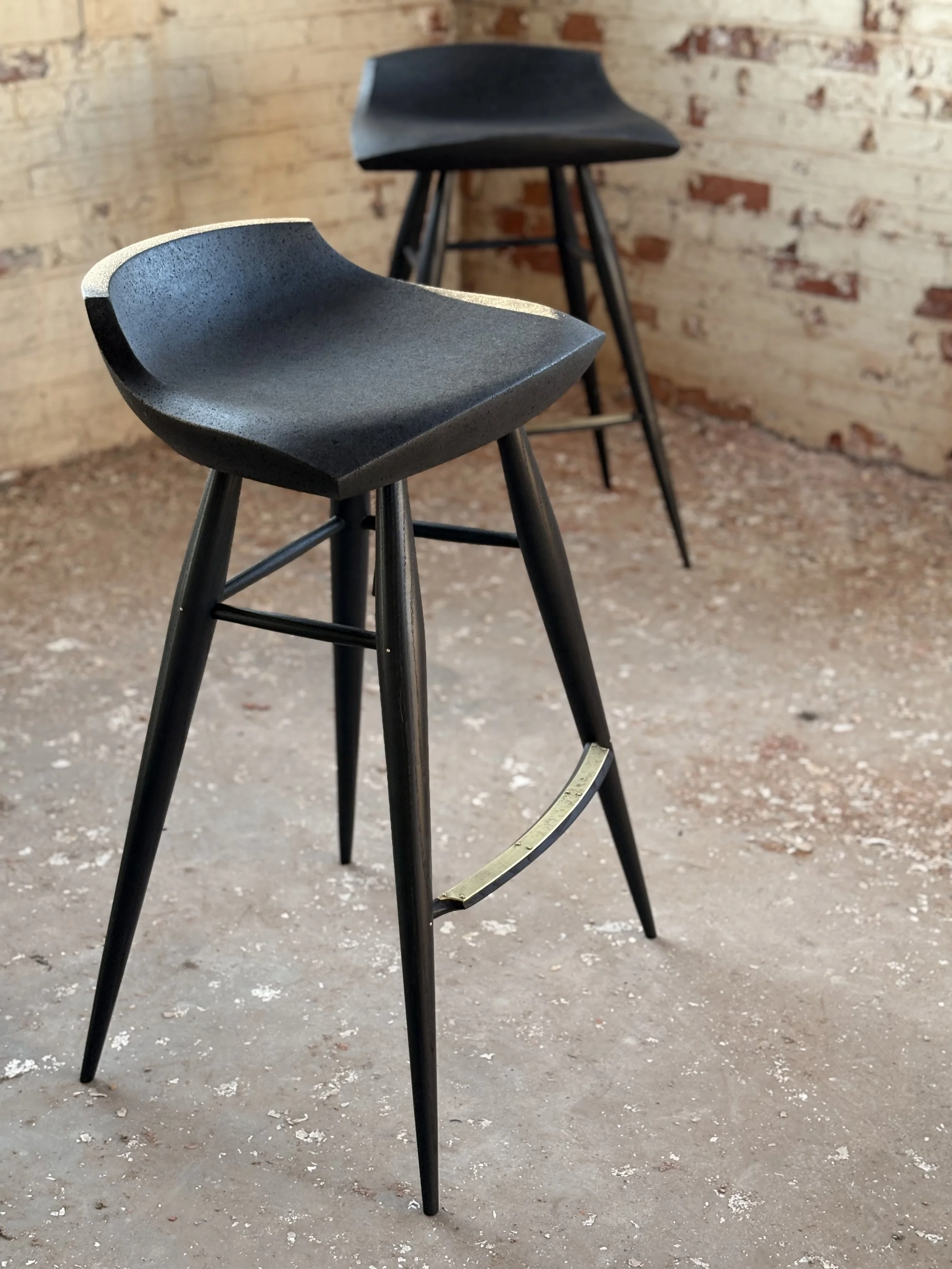 Sculpturally carved solid cork seat with turned Ash Legs with Brass footrest