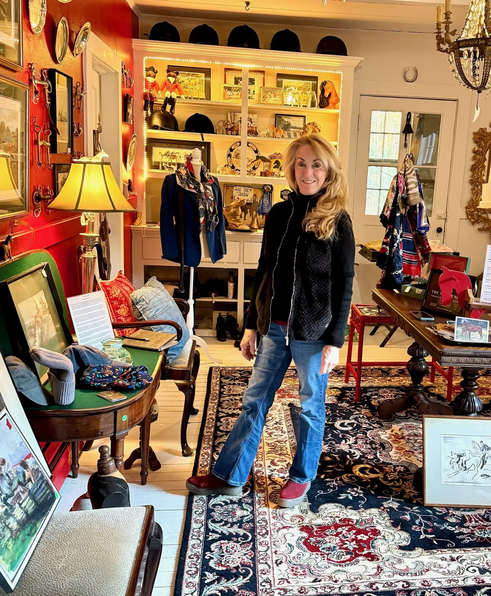 Marlyn Henry, curator of The Silver Spur, standing inside The Silver Spur filled with equestrian related items.