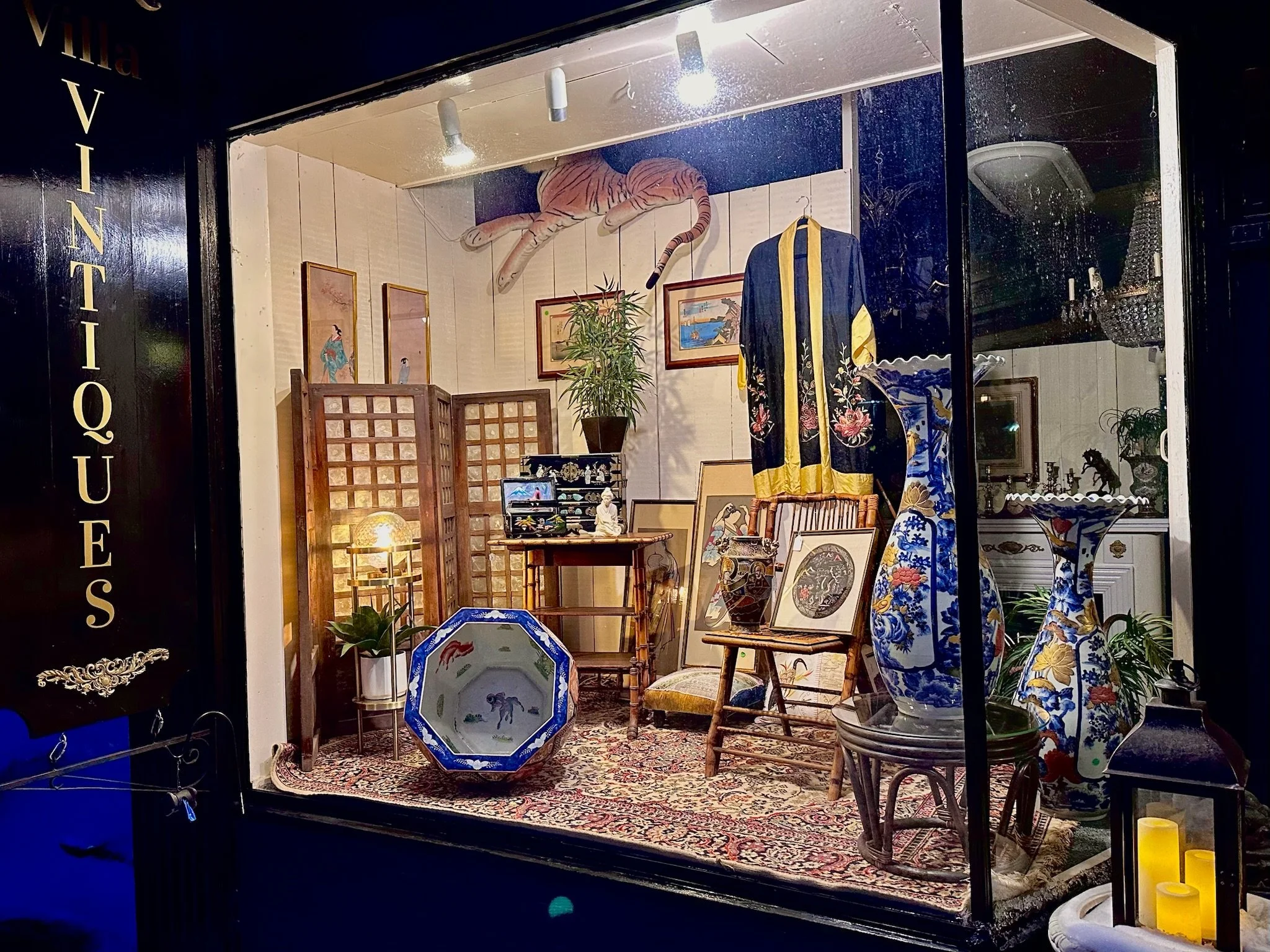 Villa Vintiques display window. Storefront window display with Asian art, porcelain vases, paintings, and furniture.