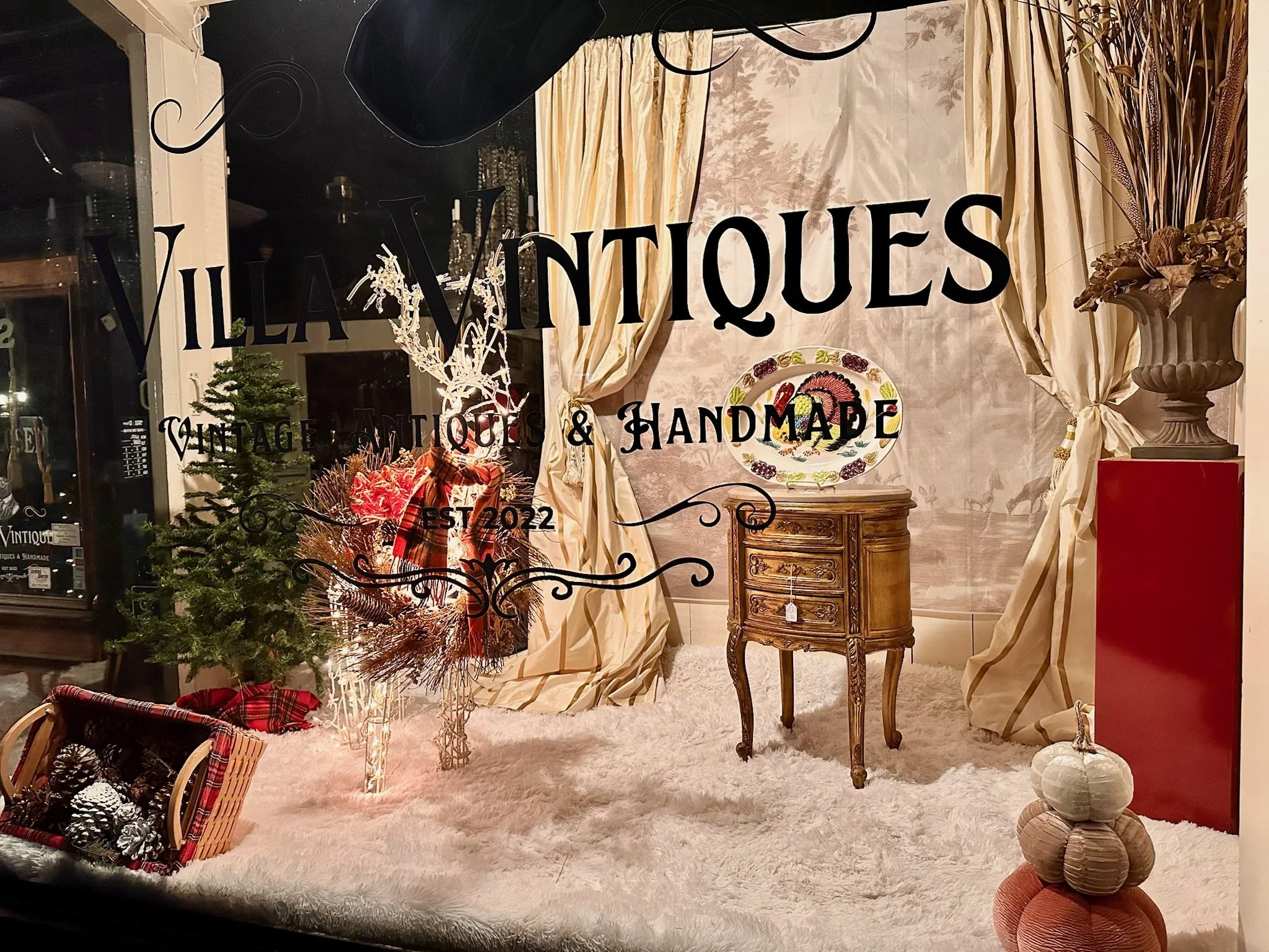 Villa Vintiques storefront display window during Christmas. The sign on window reads  'VILLA VINTIQUES, VINTAGE ANTIQUES & HANDMADE' and 'EST 2022'.