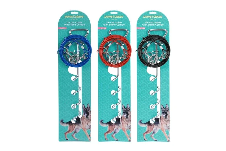 Three packages of Paws & Claws tie-out cable with stake combo, each with different colored cables: blue, red, and black, featuring metal stakes and screw-in anchors, displayed against a turquoise background with a German Shepherd dog illustration.