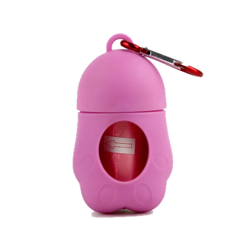 Pink pill case in the shape of a cartoon character with a small red safety pin attached at the top.