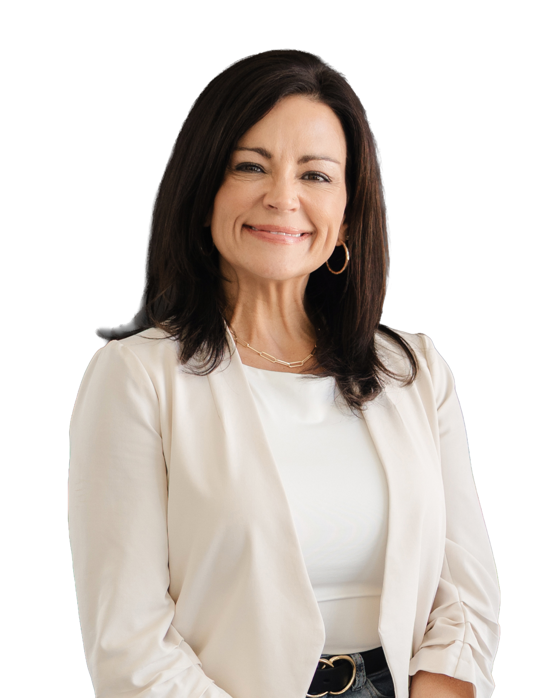 Jamie Stice | Close-up of a smiling woman with dark brown hair, wearing a white blazer, hoop earrings, a gold necklace, and a black belt, against a transparent background.