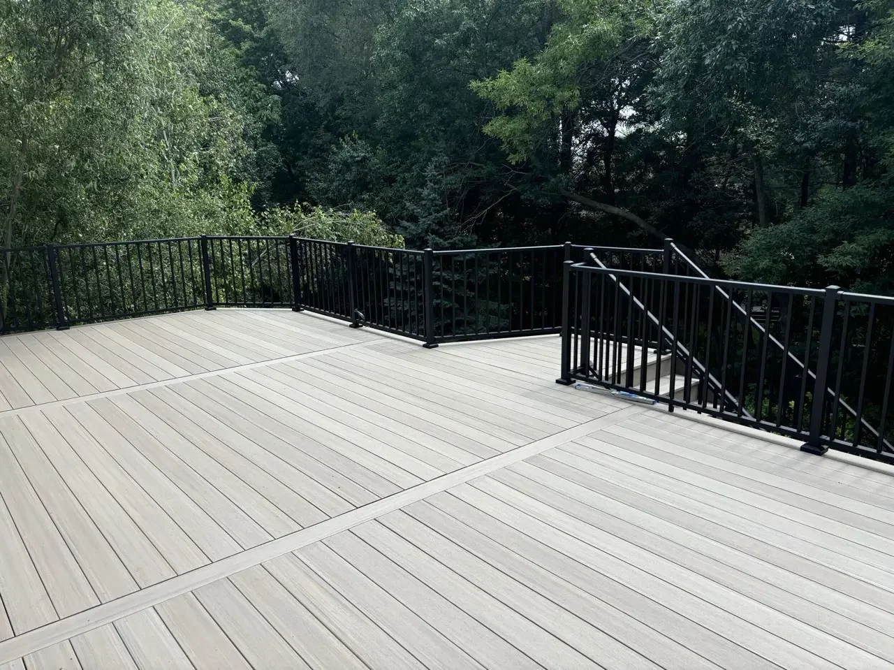 gray trex deck with black aluminum railing with angled corners