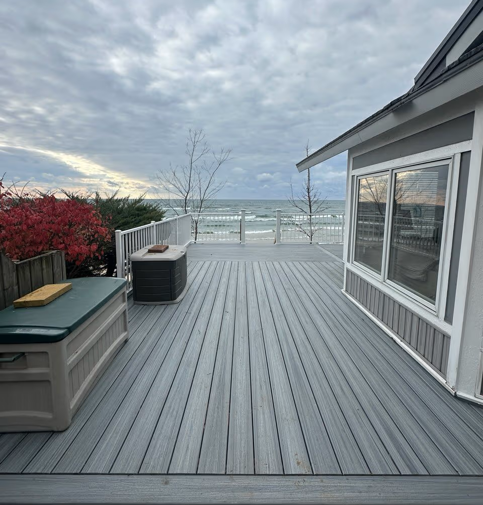 PVC deck with white Trex railing overlooking the beach on Lake Michigan.