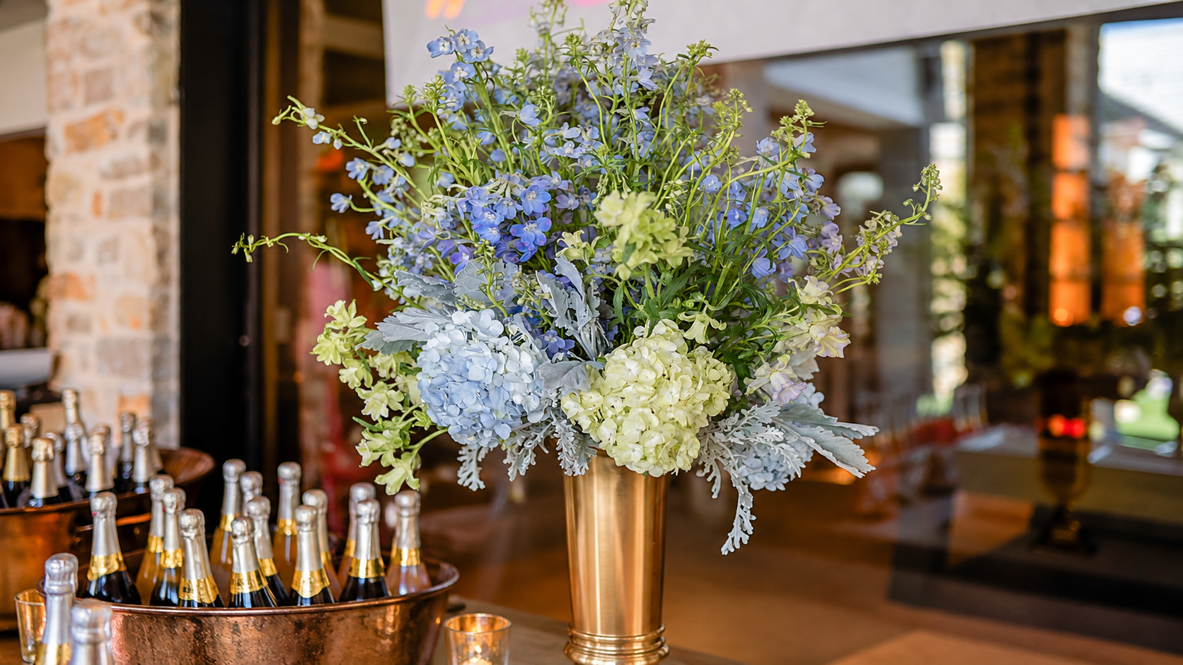 Elegant Blue Floral Arrangement in Gold Urn.png