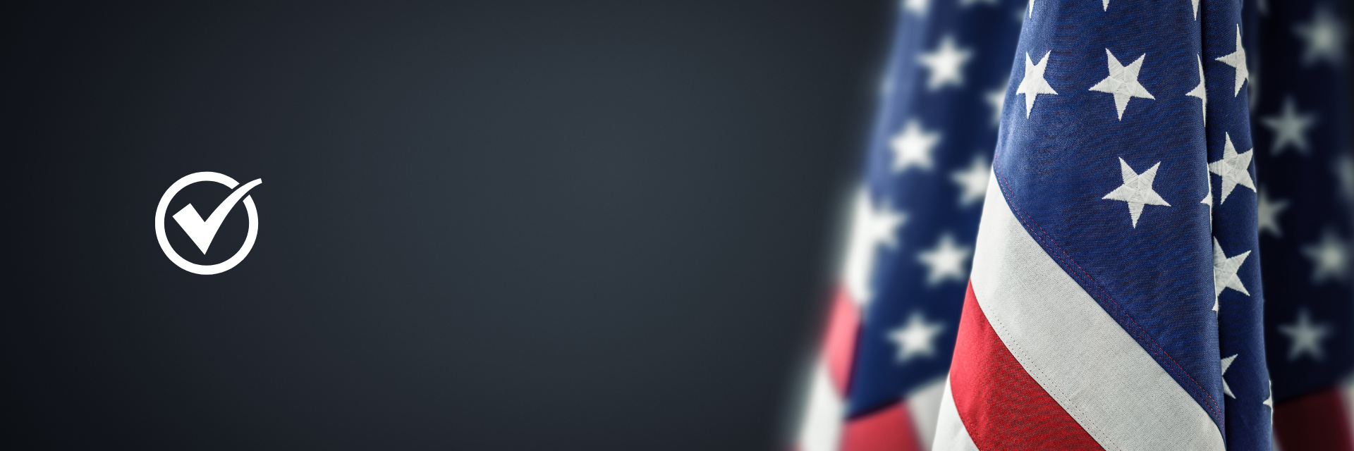 Close-up of an American flag hanging with stars and stripes visible.