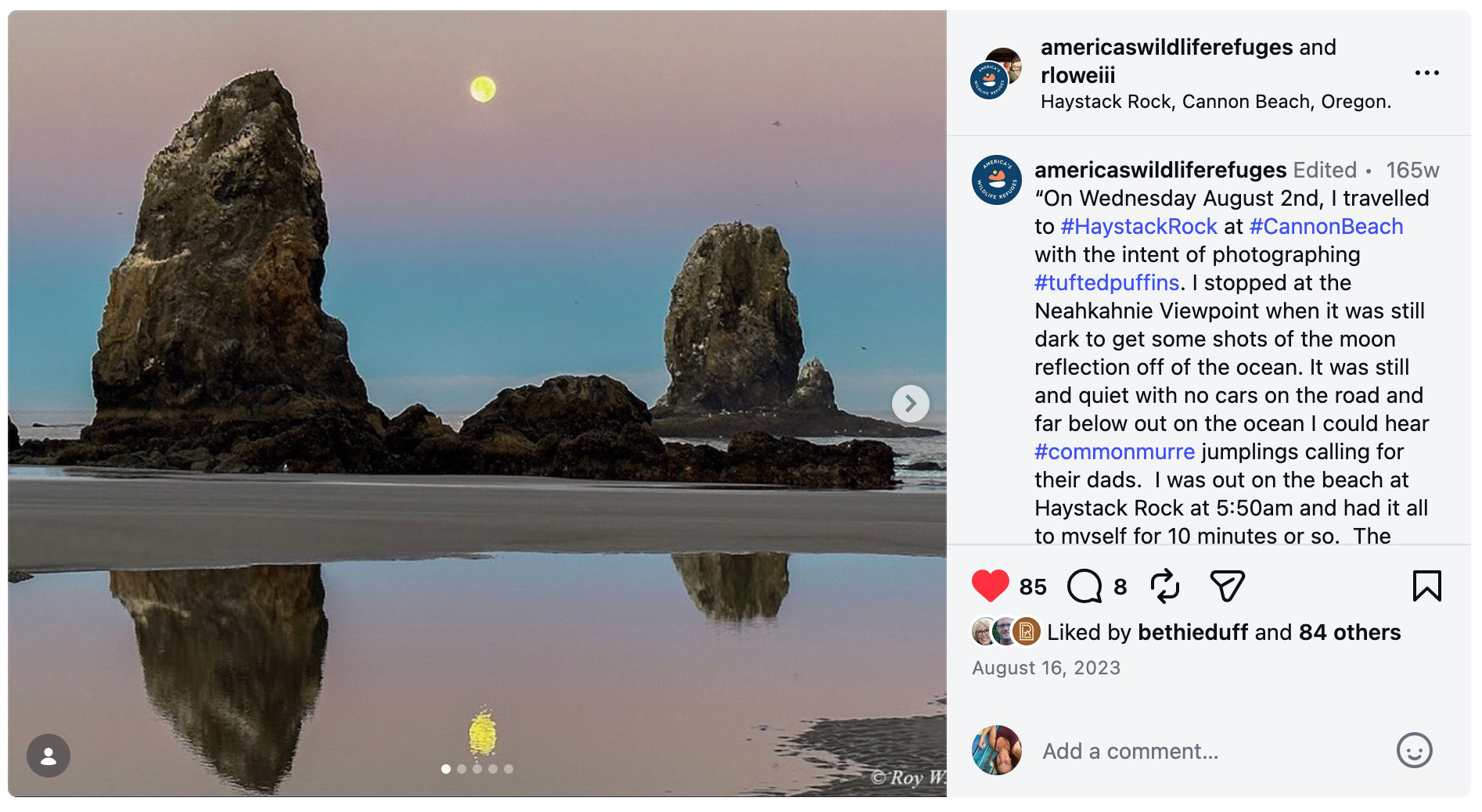 The moon rises over a pink and blue hazy sky over Haystack Rock, two large pointy rocks with smaller rocks in between, in this Instagram post