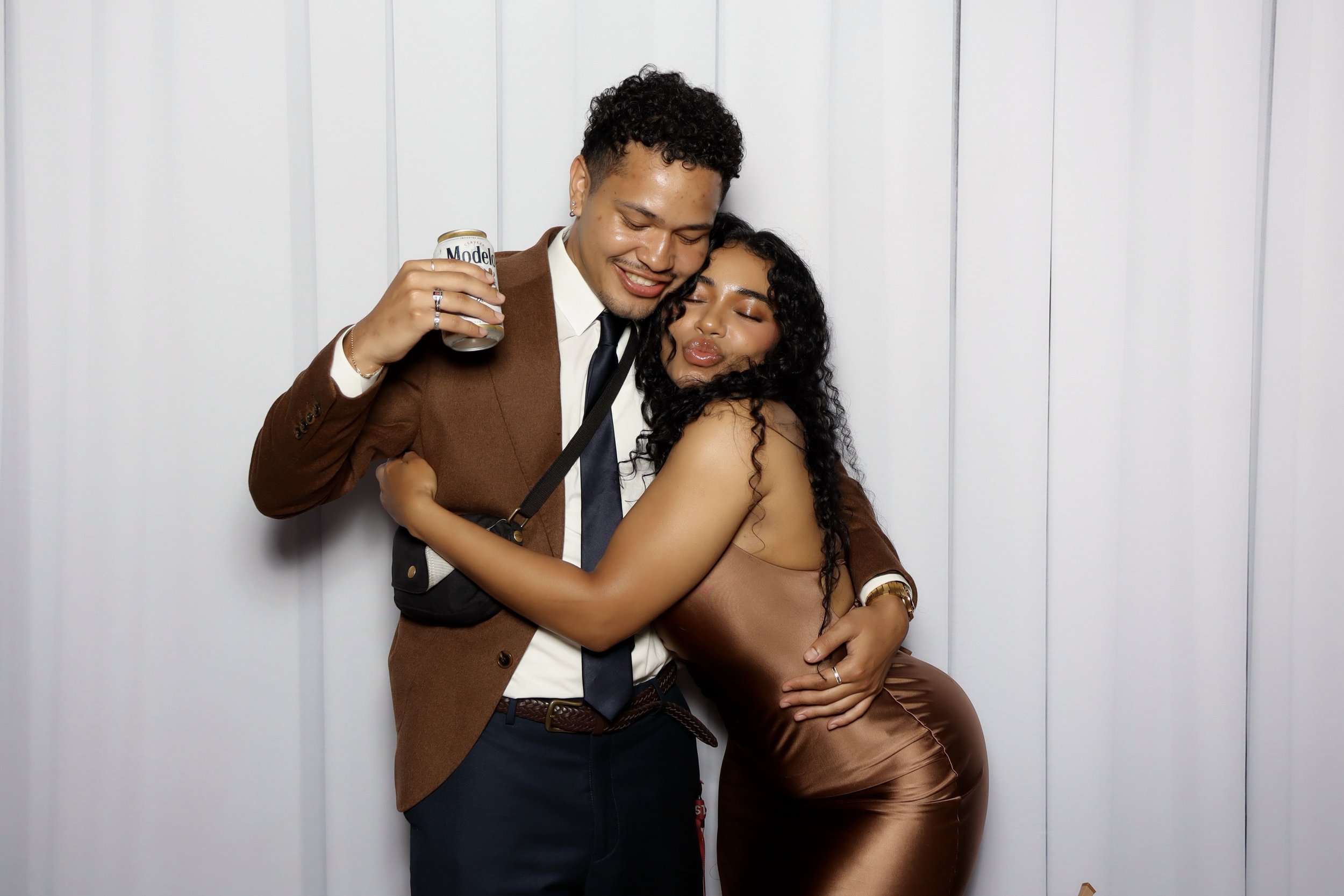 Woman hugging a man posing for a picture.