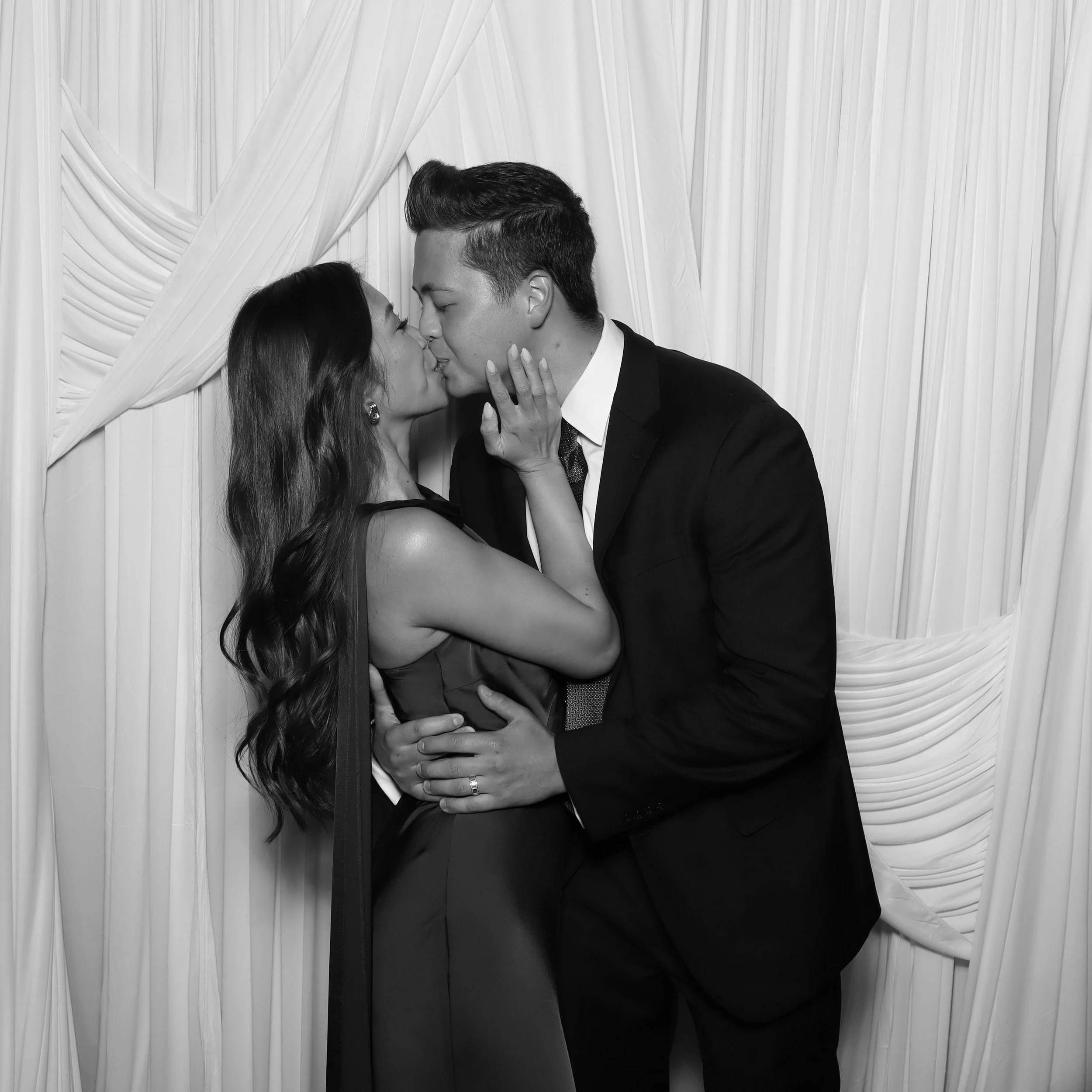 a couple kissing each other for a photo