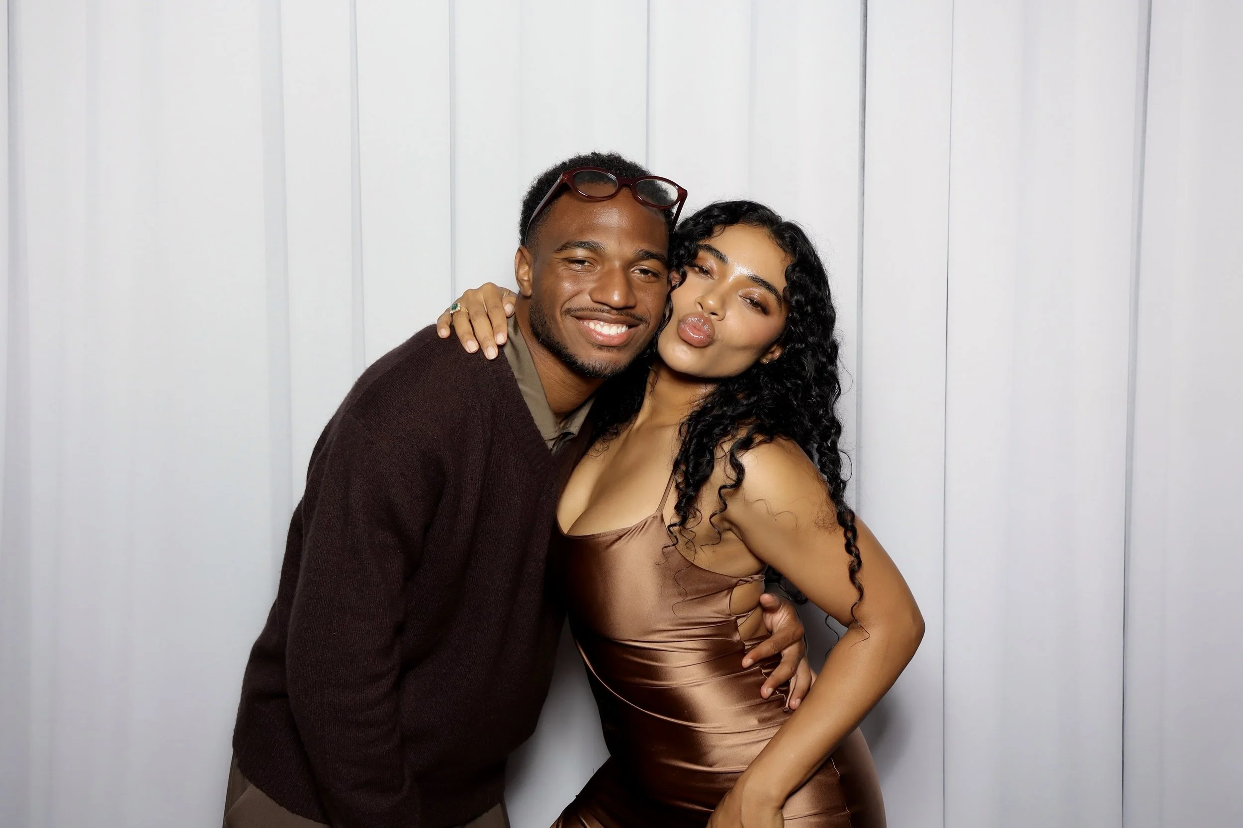 2 people posing against a nice faux drapery backdrop