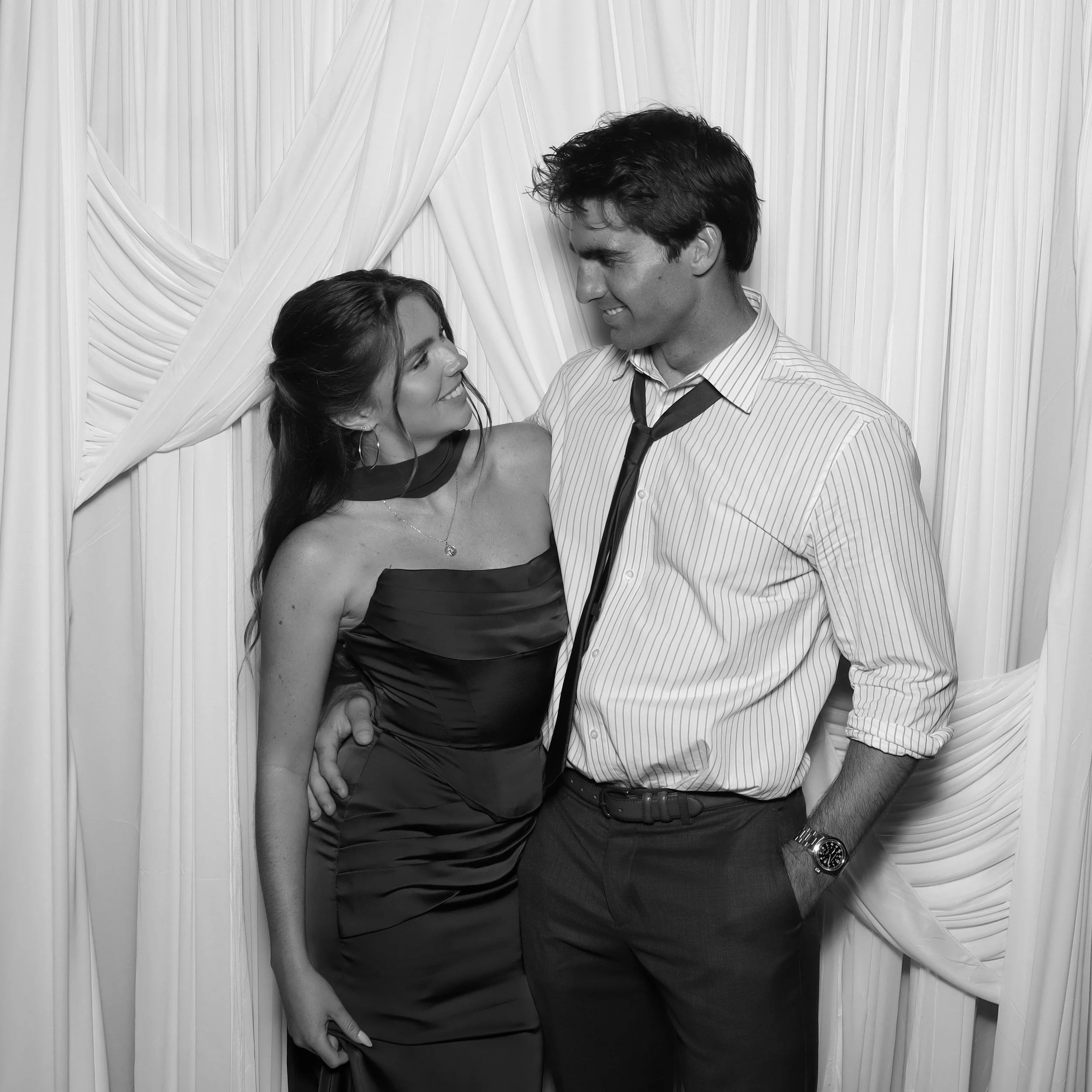 A young couple posing by looking at each other