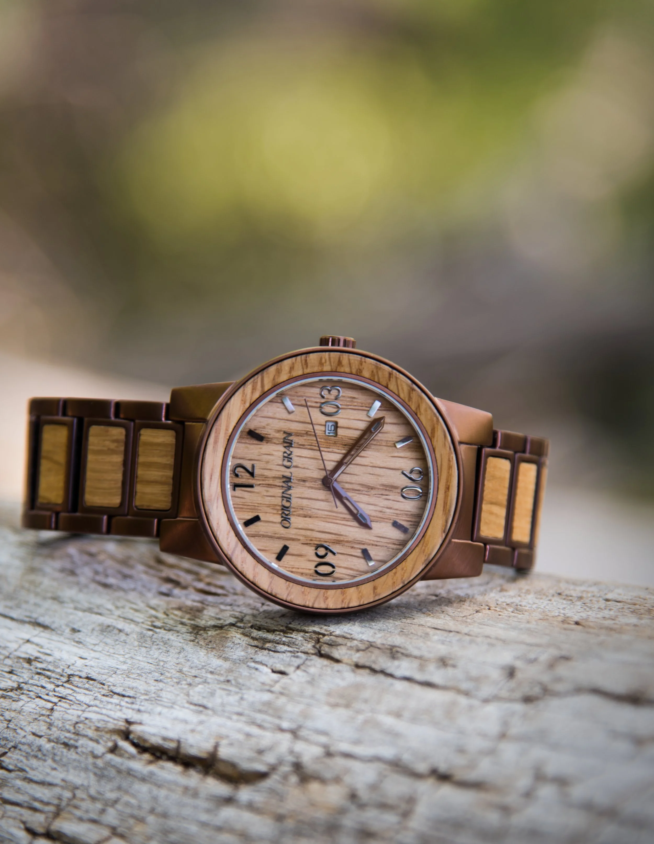 Original Grain wood watch resting on weathered log in natural outdoor setting Utah product photography