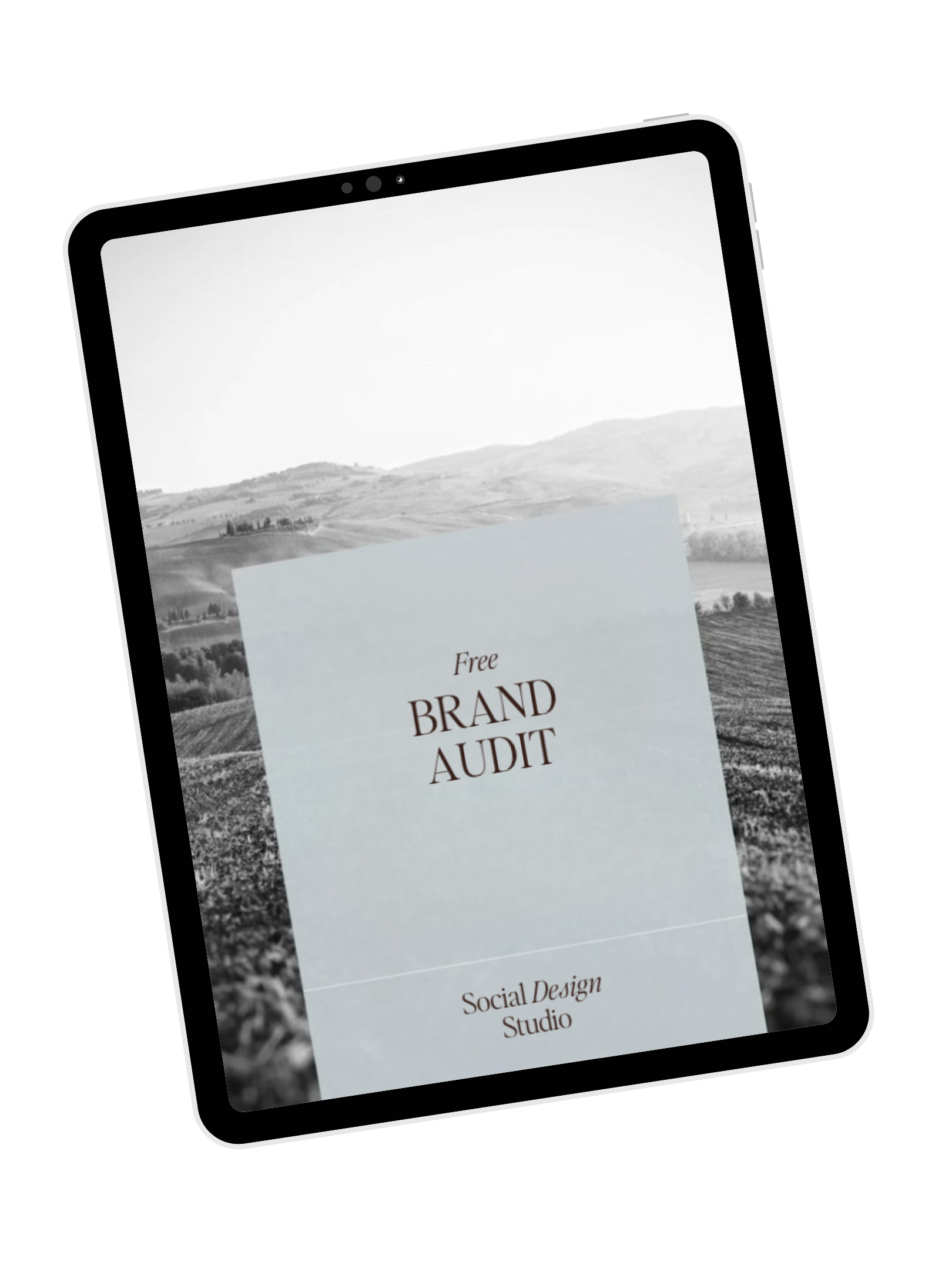 Black and white digital illustration of a tablet with a screen displaying a landscape scene and text reading 'Free Brand Audit' and 'Social Design Studio'.