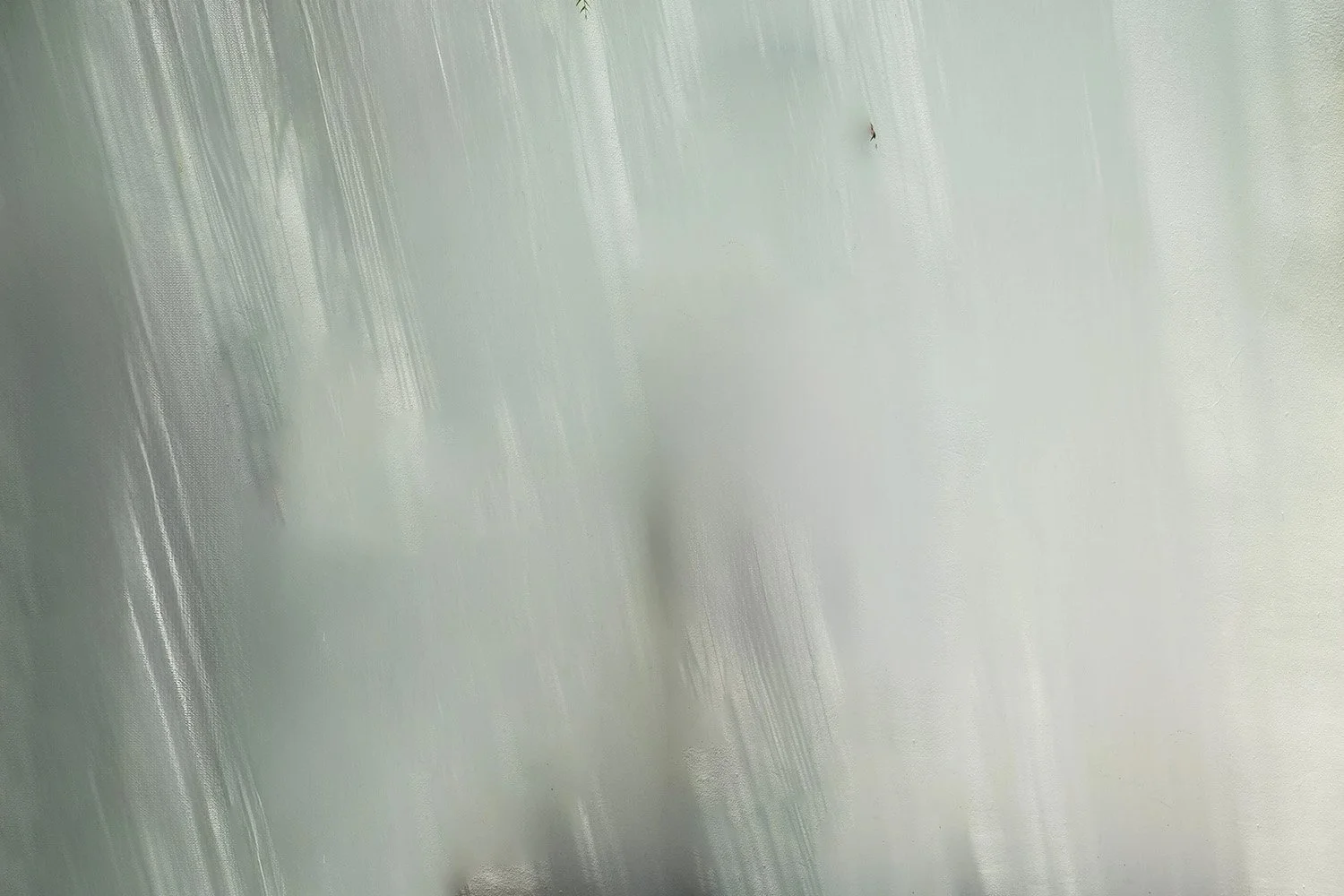 Abstract blurred image with streaks of green and blue colors.