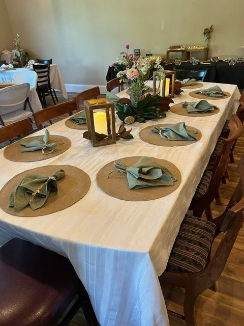 Elegant table set with lanterns, flowers, and coordinated place settings as part of a Springhill celebration experience.