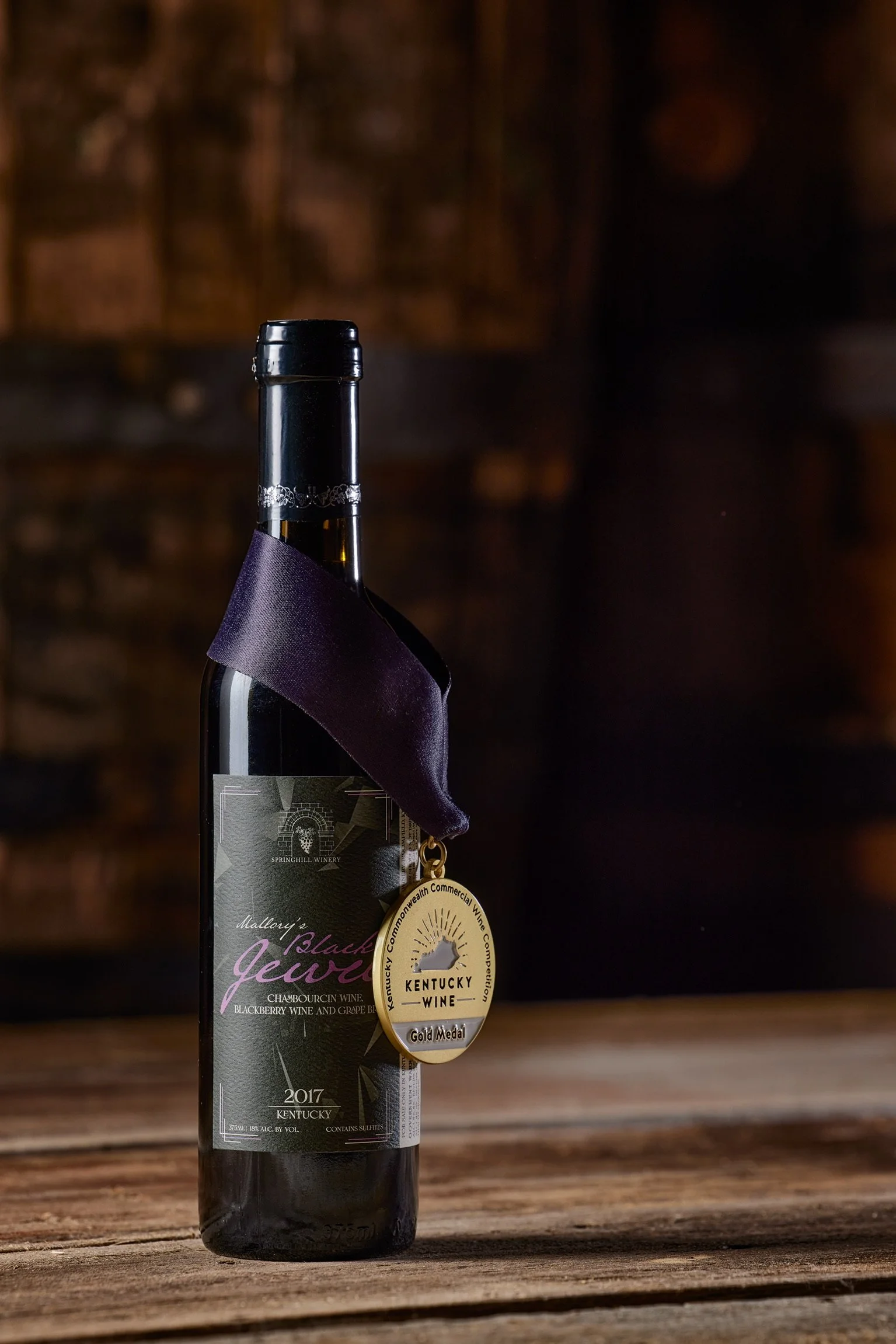 Award‑winning Mallory’s Black Jewel wine displayed with its gold medal as part of the Springhill tasting experience.