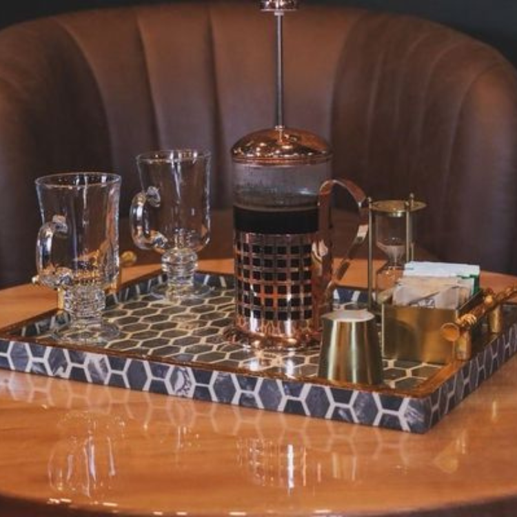 French press coffee service with glass mugs, an hourglass timer, and a decorative tray at Liam & Ash Cocktail Emporium in Bardstown, Kentucky.