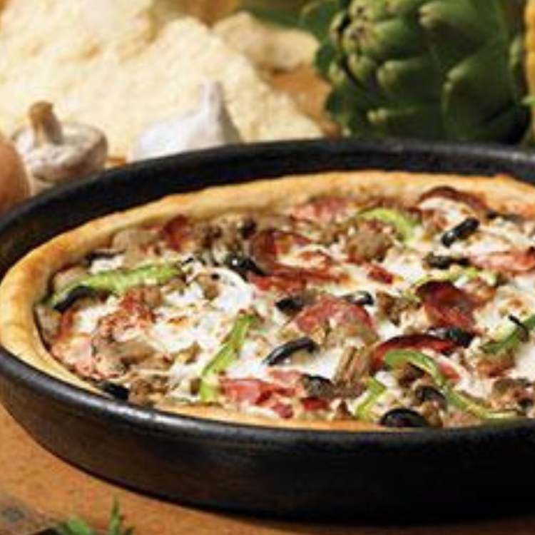 Freshly baked pizza at Hometown Pizza in Bloomfield, Kentucky, topped with sausage, pepperoni, olives, mushrooms, and green peppers in a deep‑dish pan.
