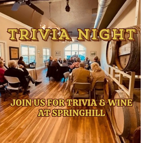 Guests seated at tables inside the Springhill Winery tasting room surrounded by wine barrels with text reading 'Trivia Night - Join us for Trivia & Wine at Springhill'.