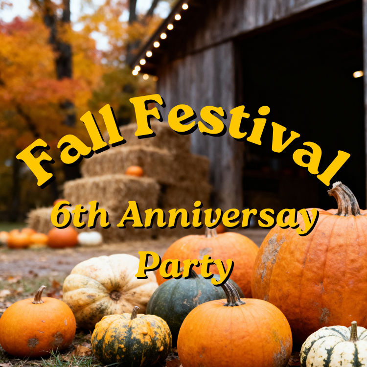 Various pumpkins with hay bales, barn and trees in the background.