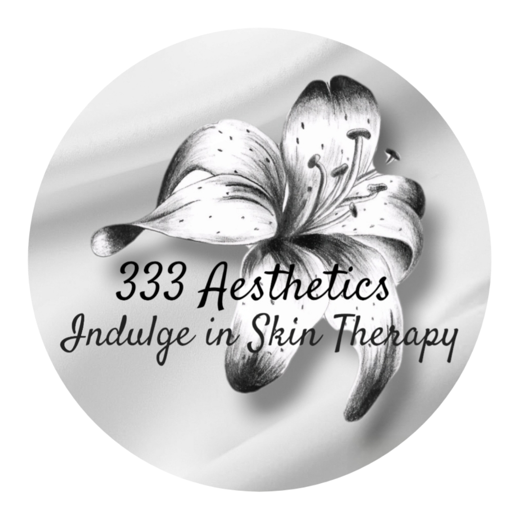 A black and white logo featuring a lily flower with the text '333 Aesthetics' and 'Indulge in Skin Therapy' written over it.