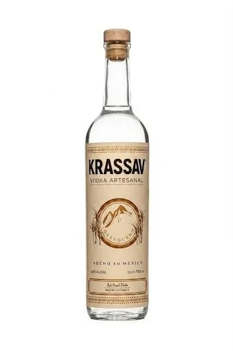 A clear glass bottle of Krassav vodka with a beige label and cork cap.