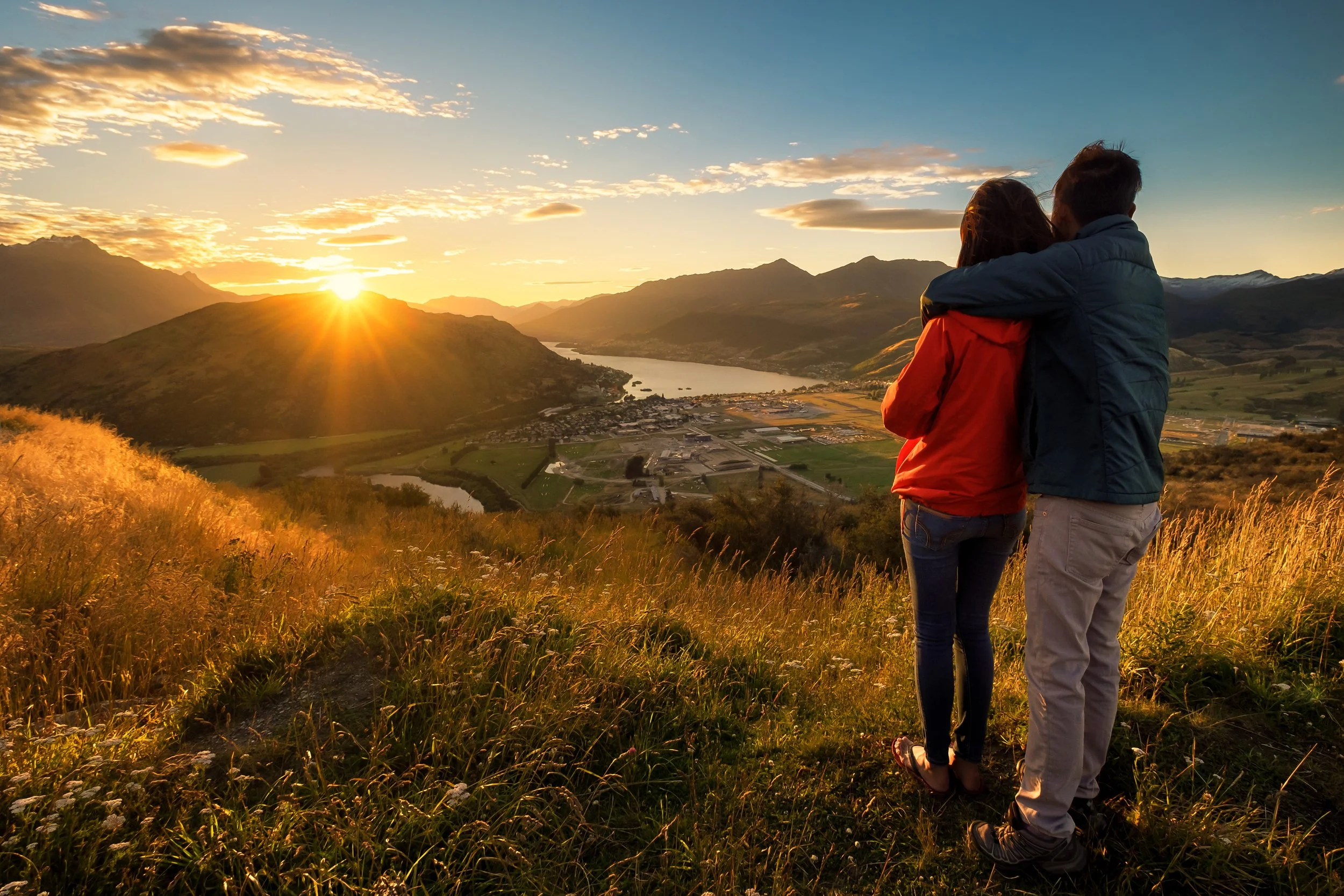 A couple enjoying a Queenstown sunset as part of their tour.