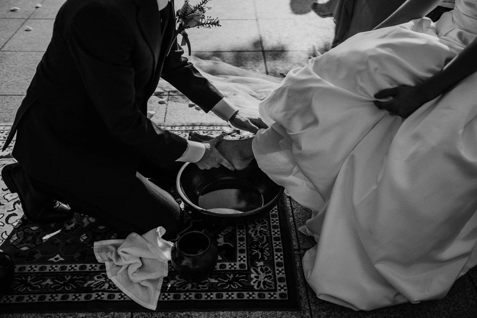 Bride and groom feet washing ceremony close-up — fusion wedding photography by Weddings by Qay