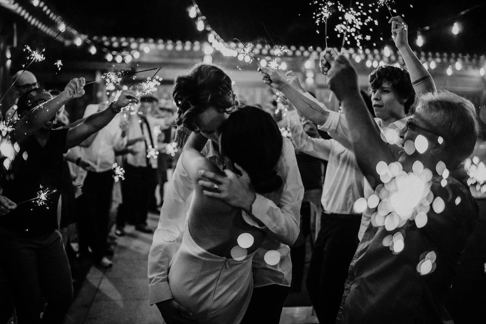 Wedding sparkler exit — night photography by Weddings by Qay