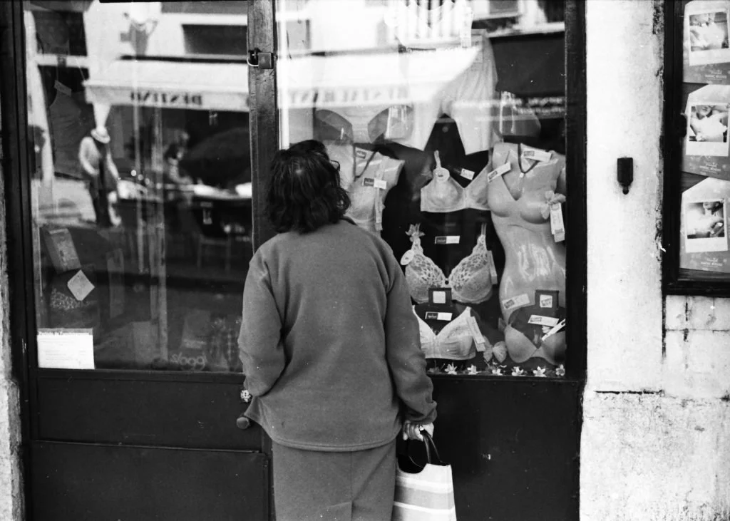 Women's underwear shop Lisbon with window shopper on a Saturday afternoon