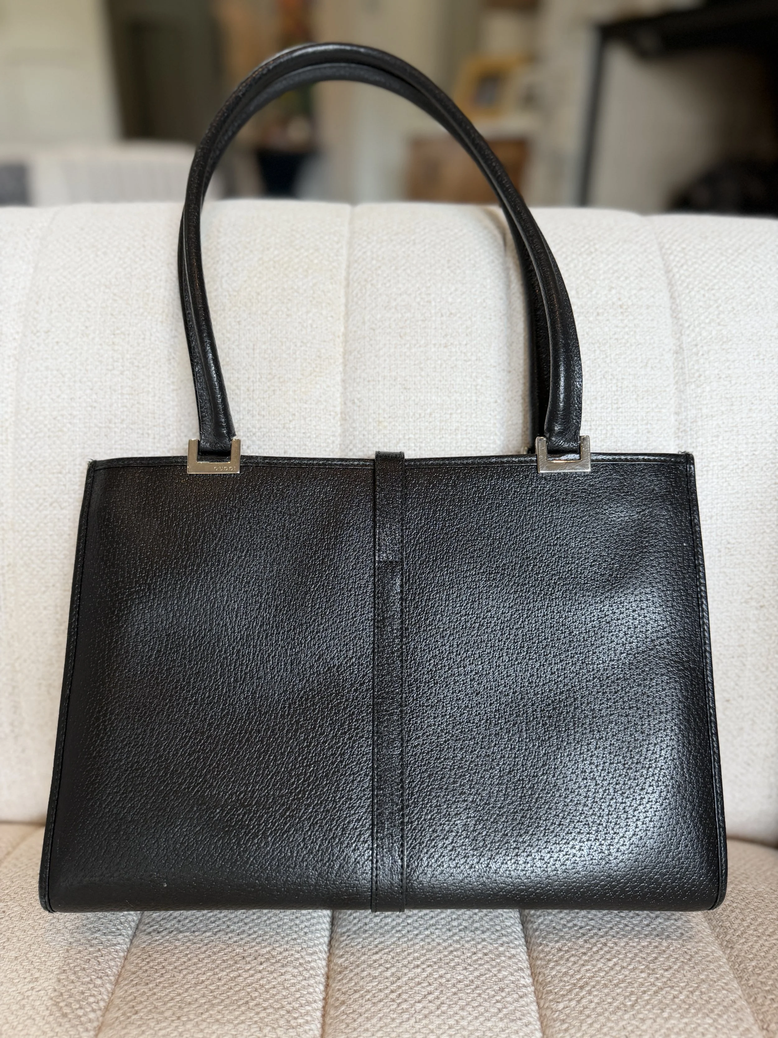Back view of black leather Jackie tote highlighting texture and silhouette
