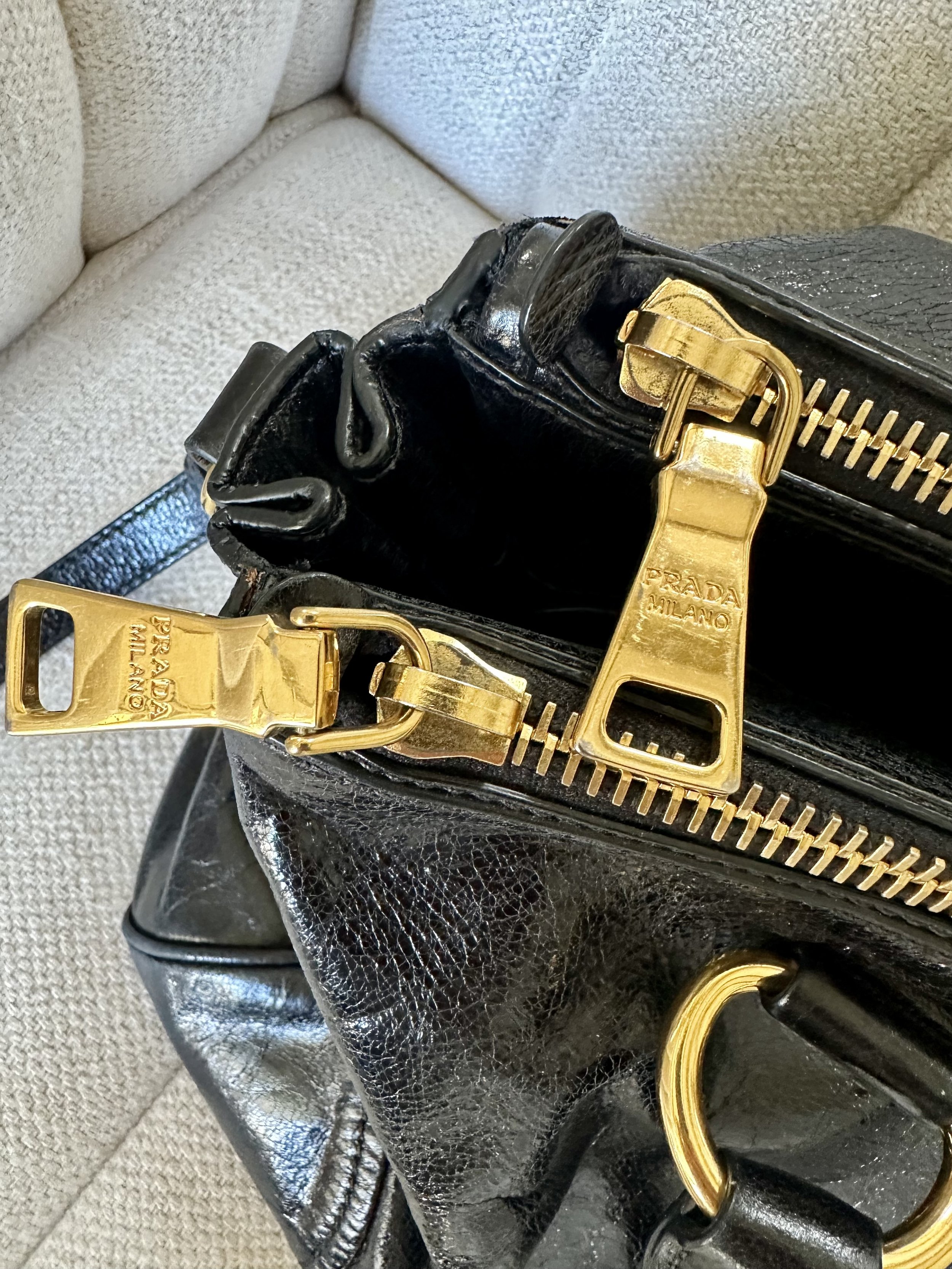Prada Vitello Shine Satchel PRADA MILANO engraved gold zipper pull detail close up