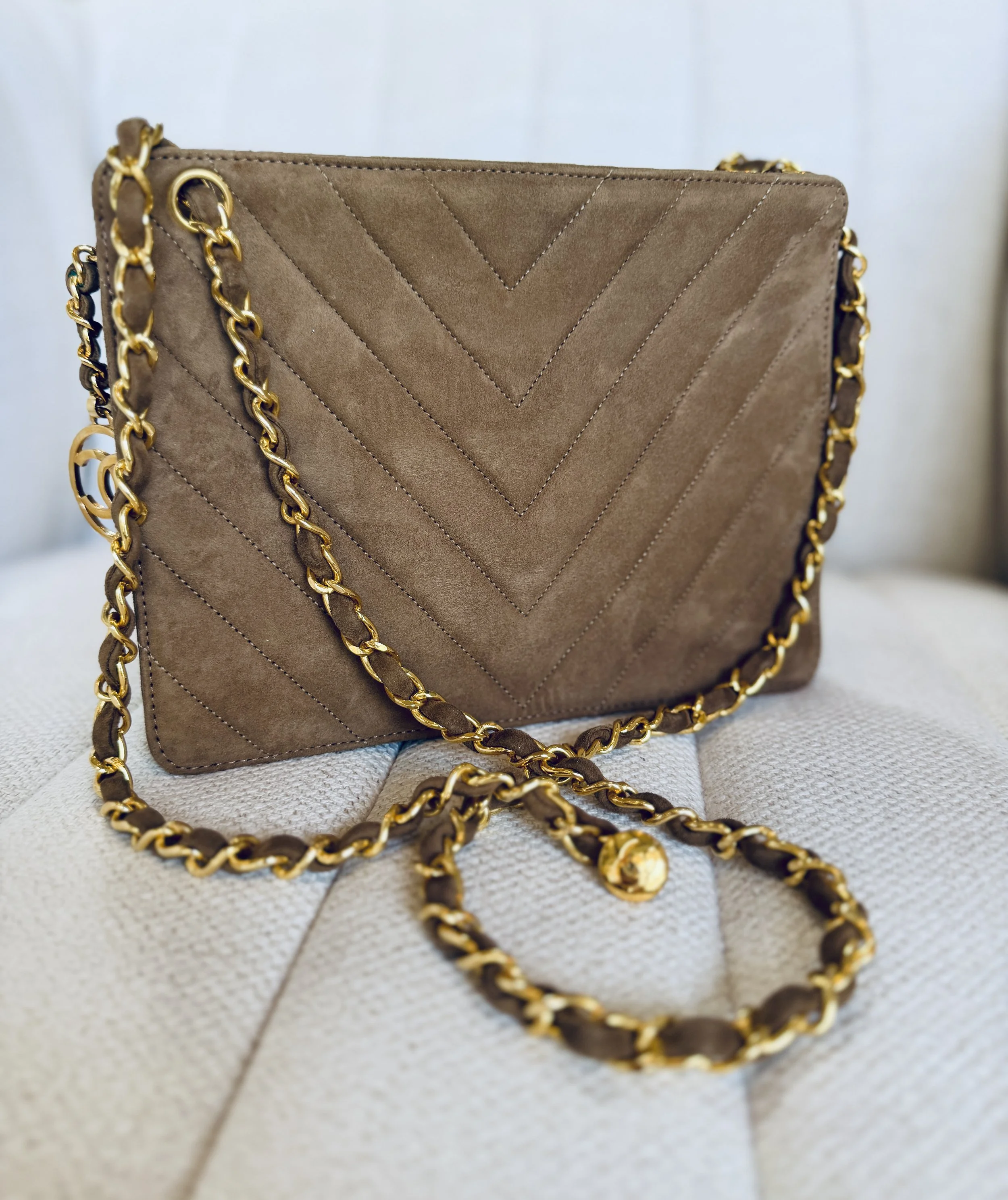 Chanel vintage chevron quilted suede bag, front view with chain strap