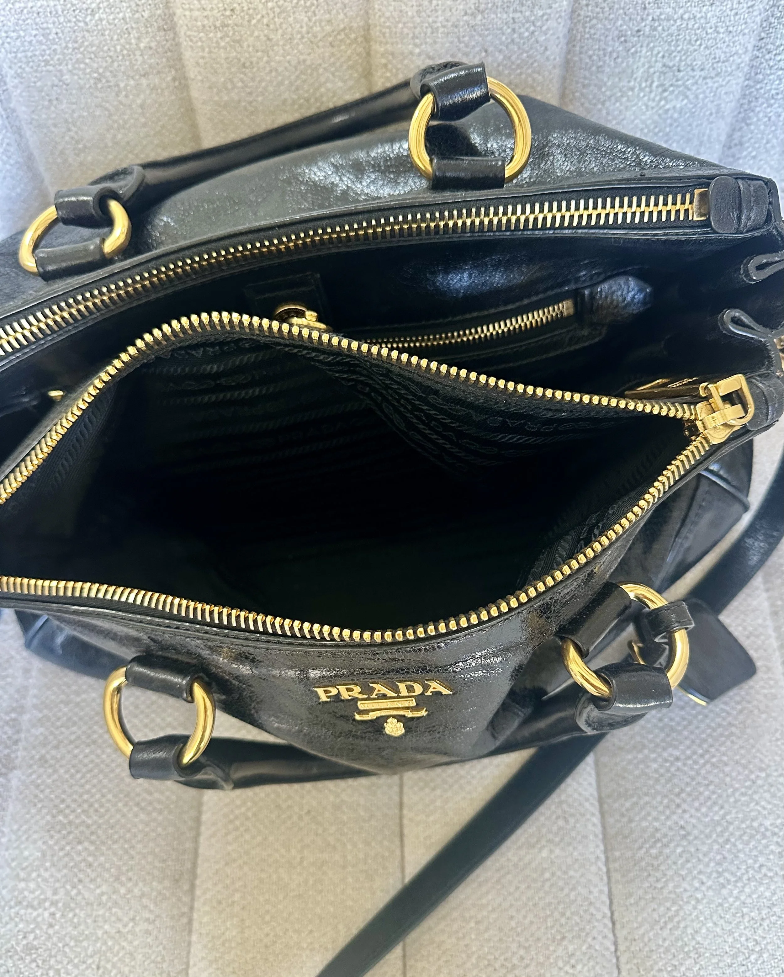 Prada Vitello Shine Satchel interior open view multiple compartments gold zipper pulls
