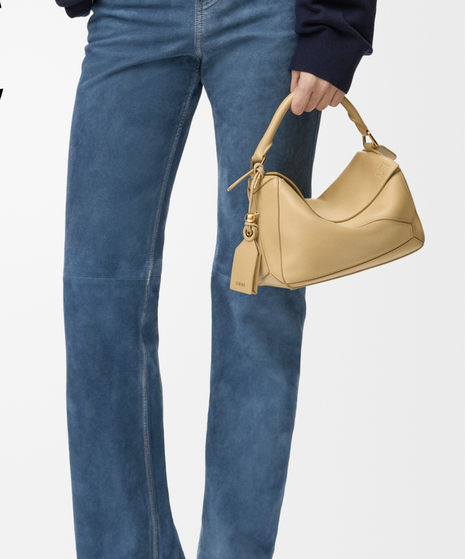 Loewe Small Featherlight Puzzle bag in Dark Butter, held by handle