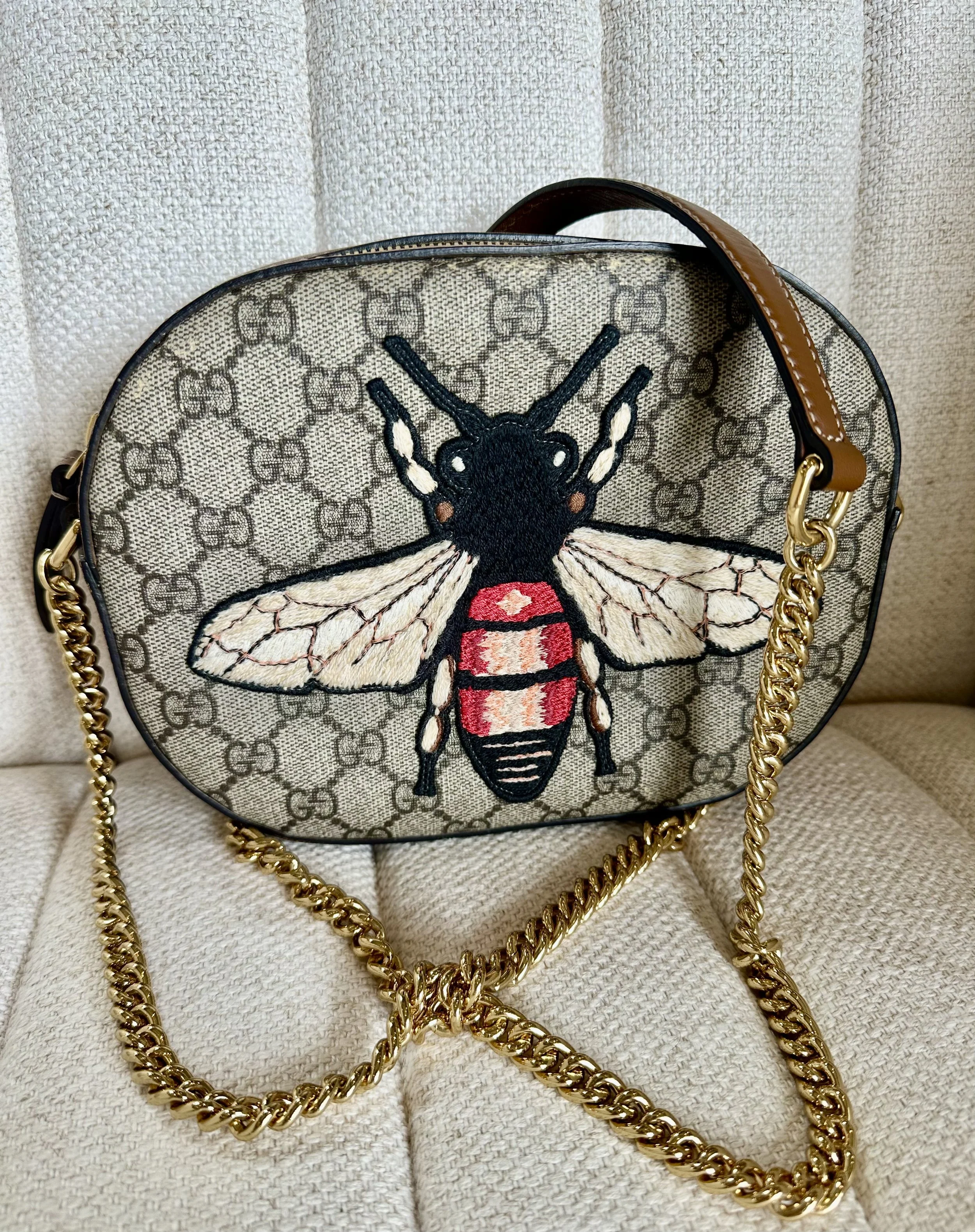 Gucci GG Supreme Bee bag on cushion, front detail