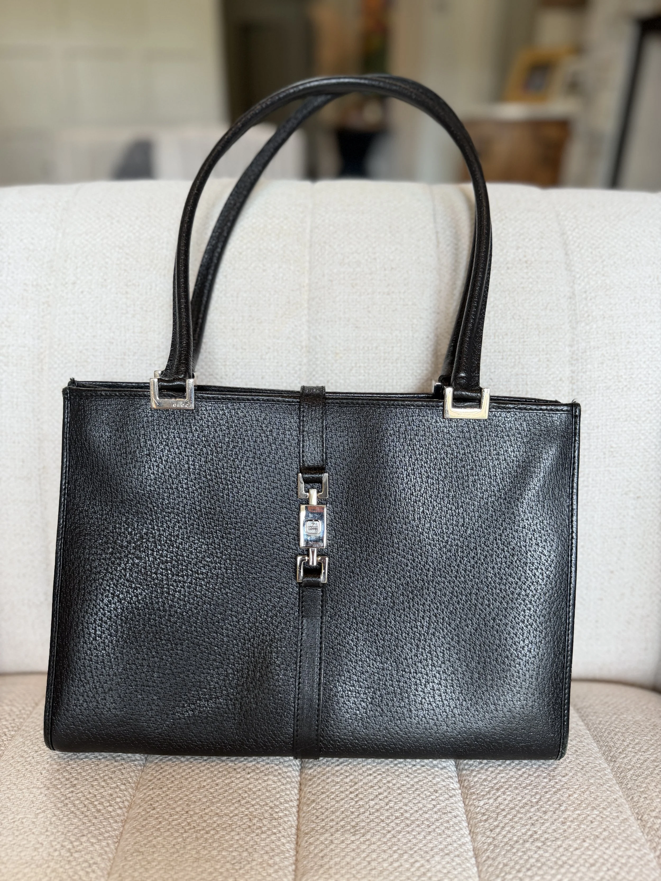 Front view of Tom Ford-era Gucci Jackie shoulder tote in black leather with piston-style closure