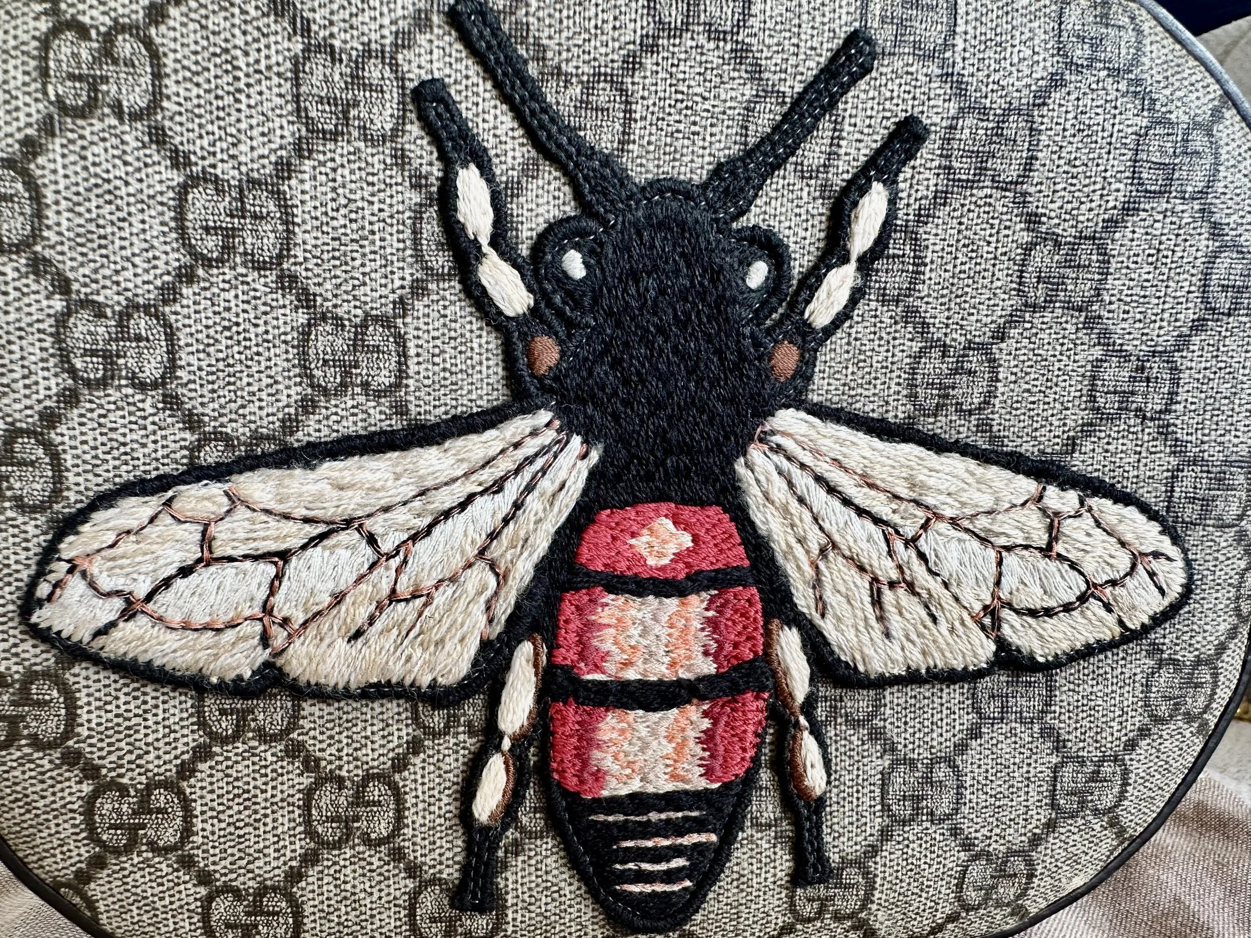 Gucci bee embroidery macro detail, multicolor thread wings