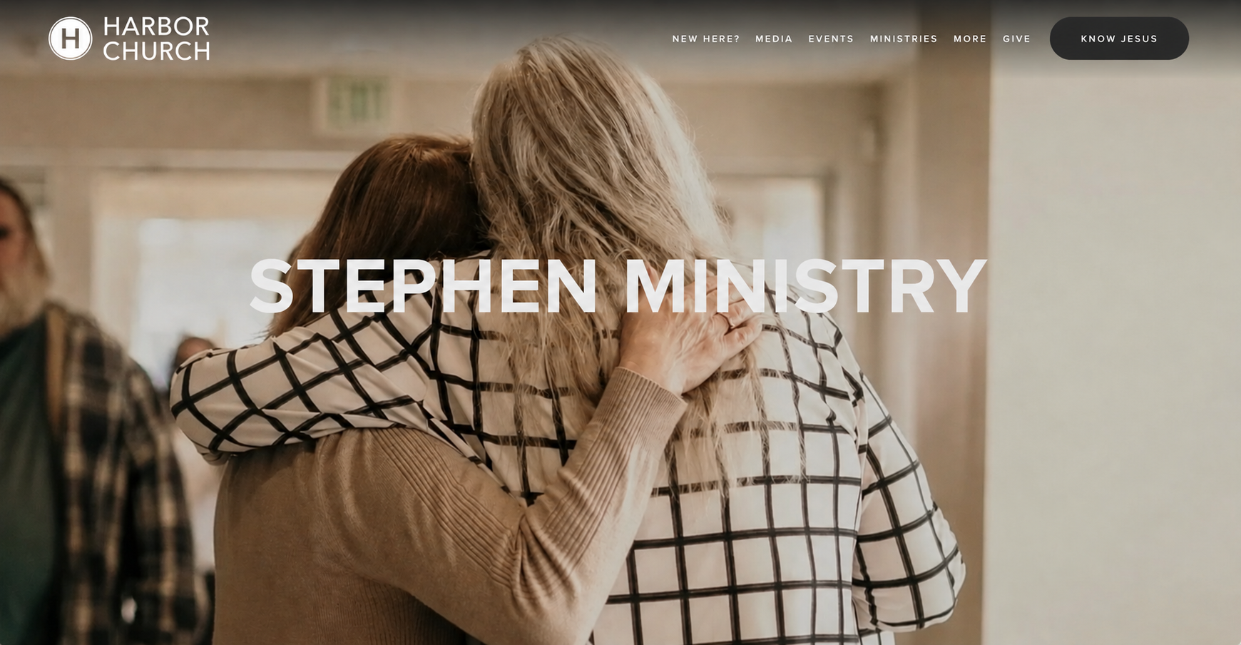 Two women hug inside a church, with the text "Stephen Ministry" overlaid on the image.