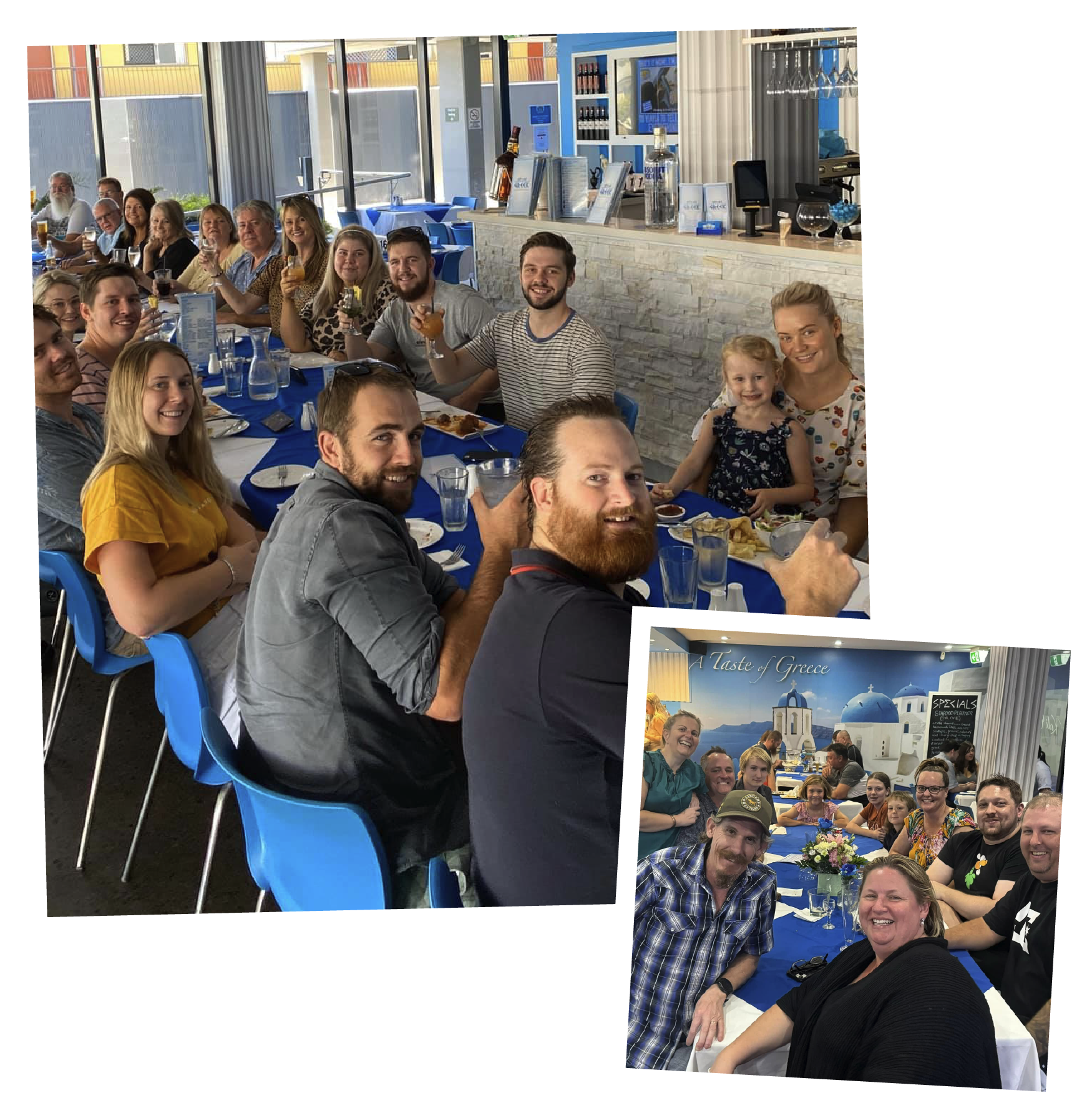 A group of people gathering at a restaurant or café, smiling and enjoying drinks at a long table with blue tablecloths, in front of a large window. Some are holding beverages, and there is a child sitting with an adult. The indoor setting features a bar area with alcohol bottles and a decorative backdrop of Greek-themed imagery, including blue-domed buildings and the phrase 'A Taste of Greece'.