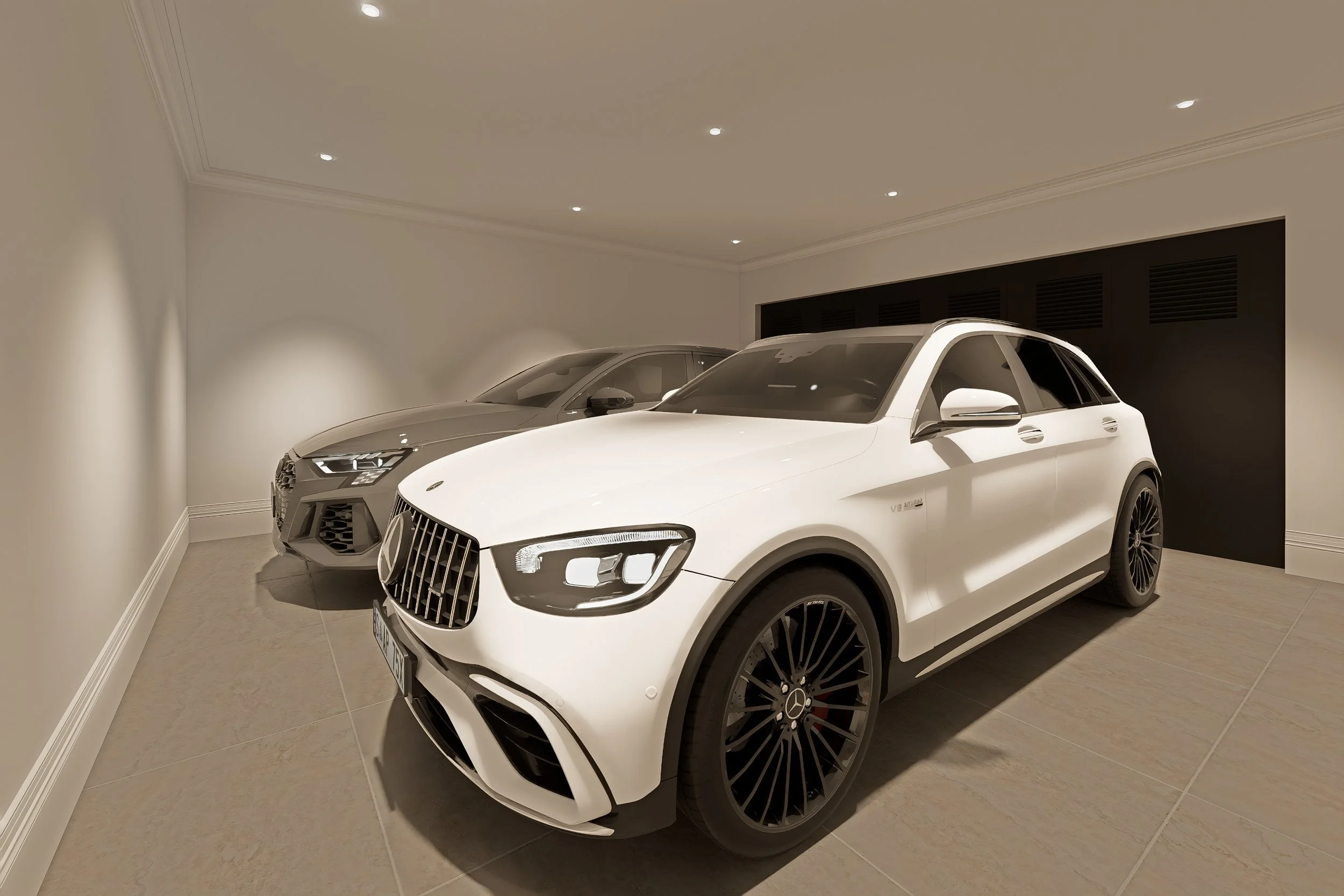 Two luxury cars parked in a modern indoor garage with beige walls and tiled floor. One is a white Mercedes-Benz SUV, and the other is a silver Audi sedan.