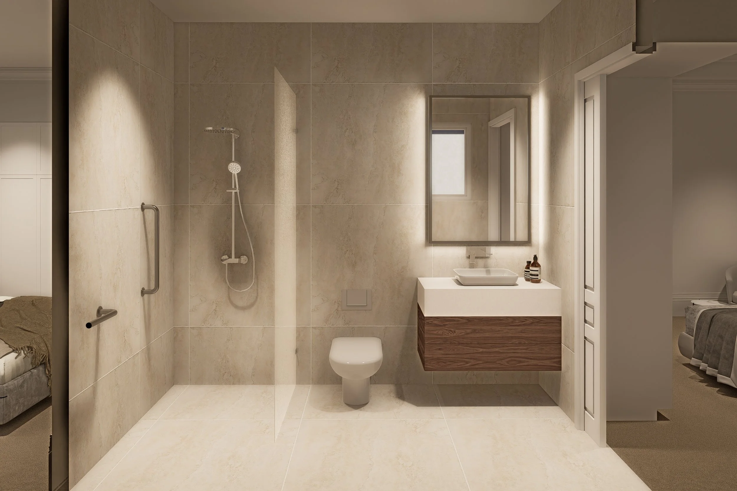 A modern bathroom with beige tiled walls and floor, a wall-mounted shower head, a mirror above a white sink with a wooden cabinet, a small window, and a partial view of a bedroom with a bed and side table.